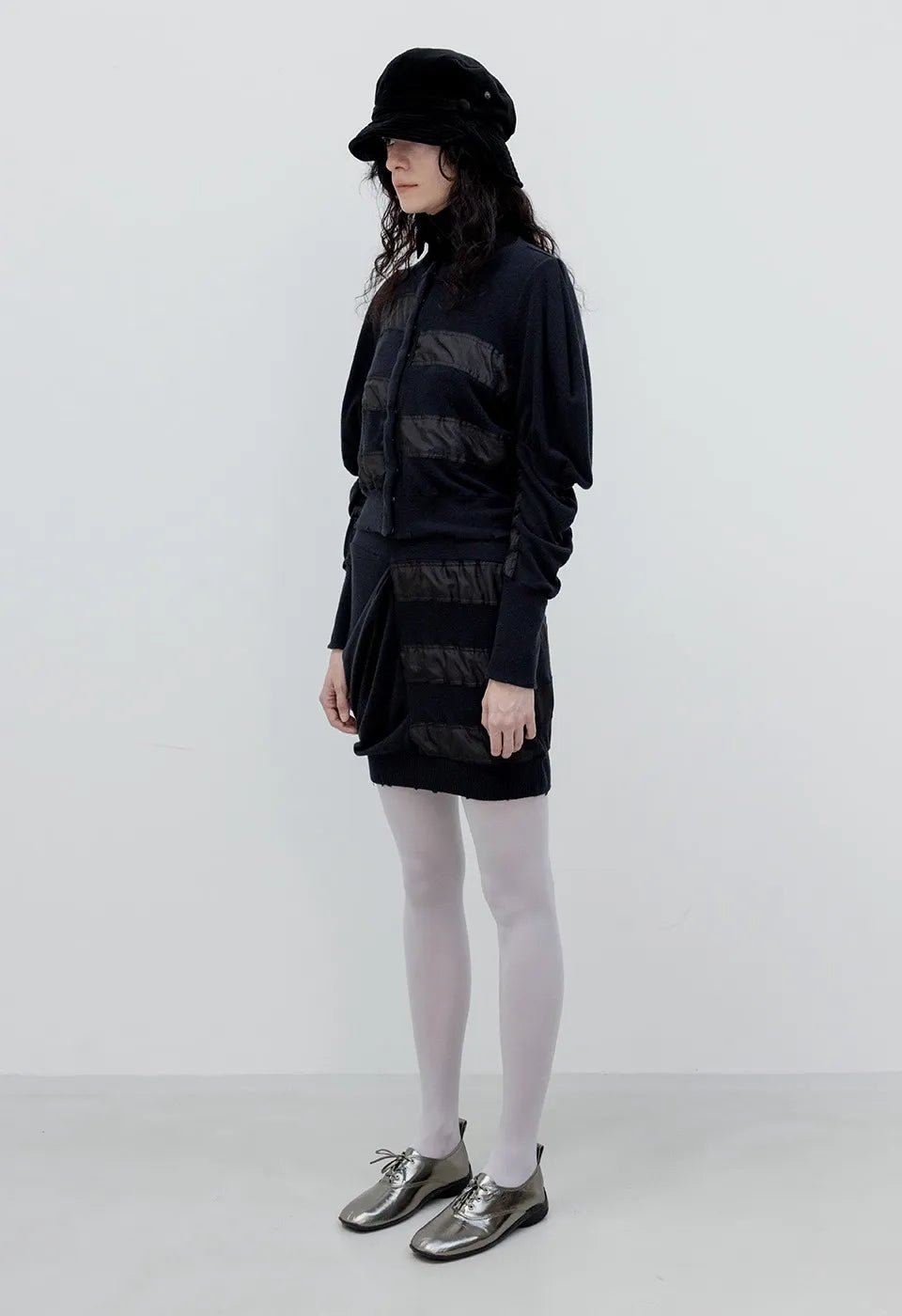 Side view of OPENYY Knitted Slouchy Panel Skirt in Black worn