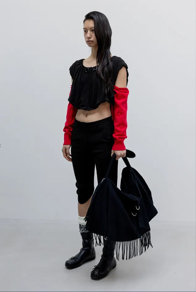 Side view of OPENYY Round Cut Capri Shorts in Black worn
