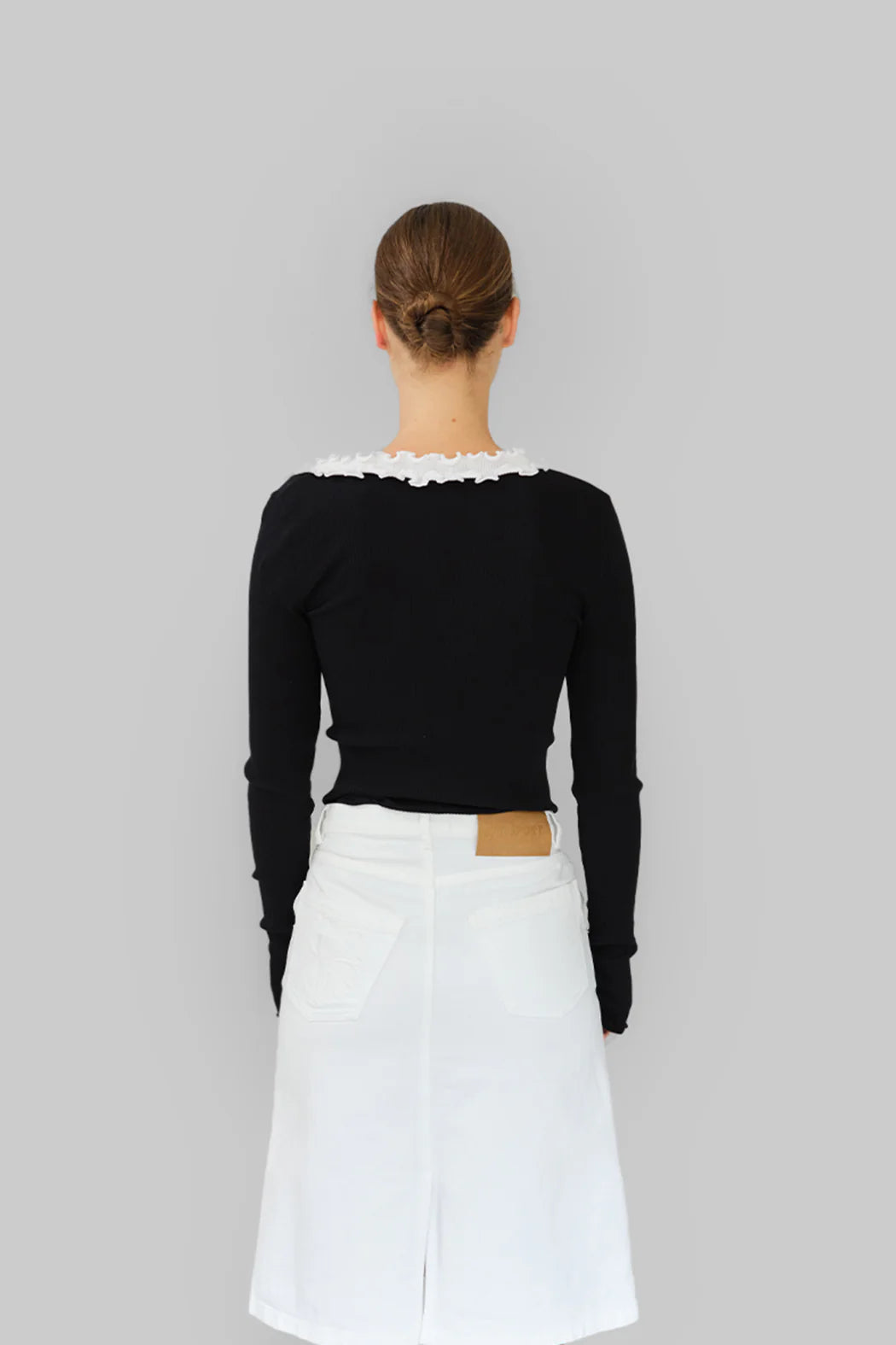 Model wearing OperaSPORT Evita Seamless Top Black back view