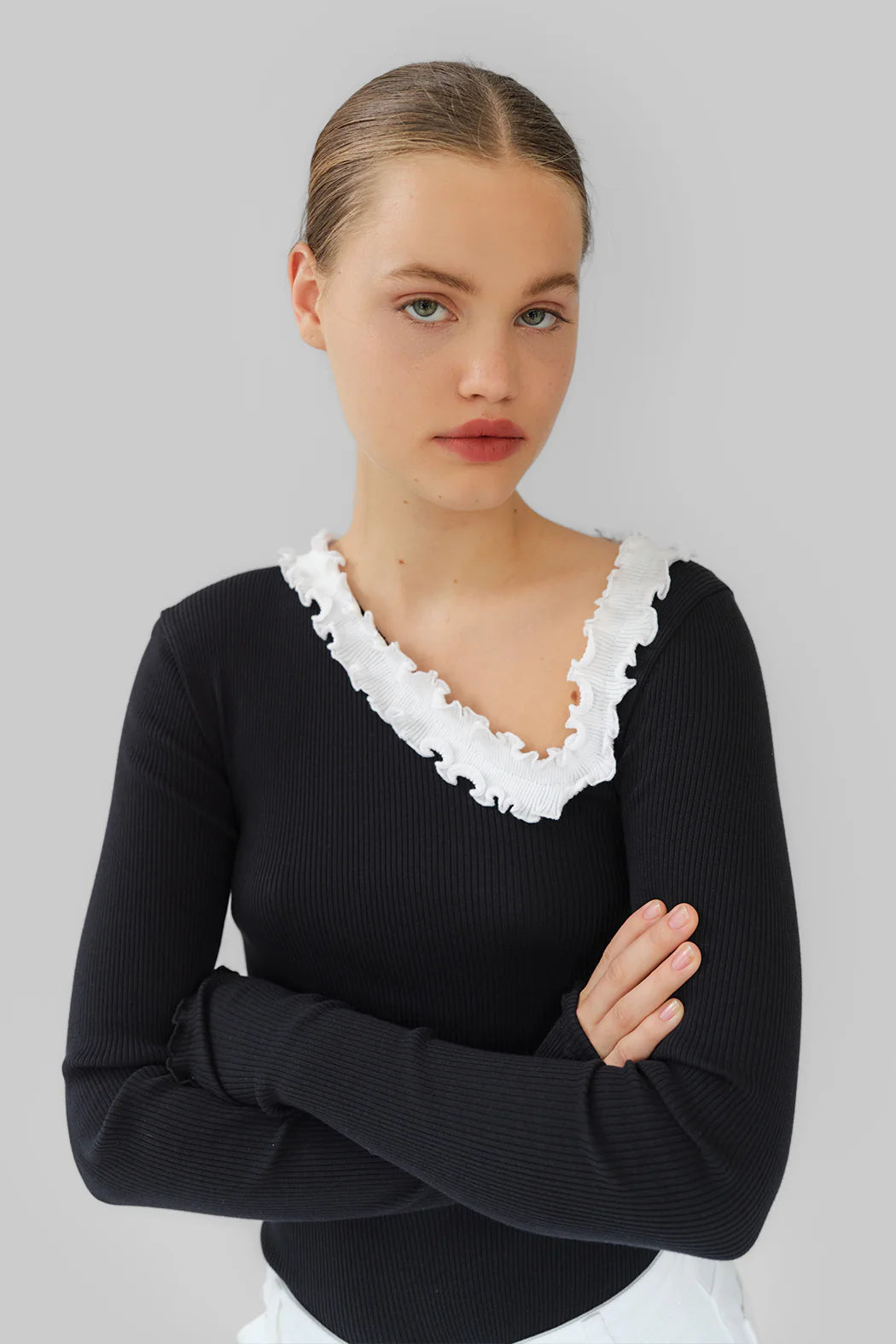 Model wearing OperaSPORT Evita Seamless Top Black close-up