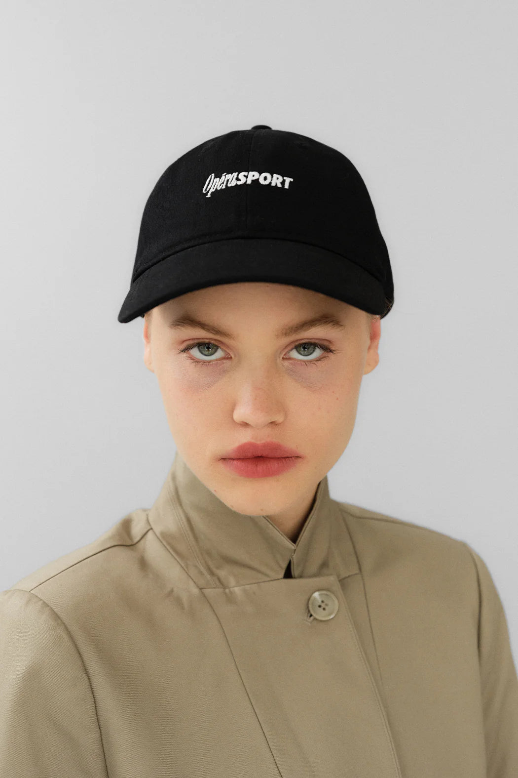 Model wearing OperaSPORT Rene Unisex Cap Black front view