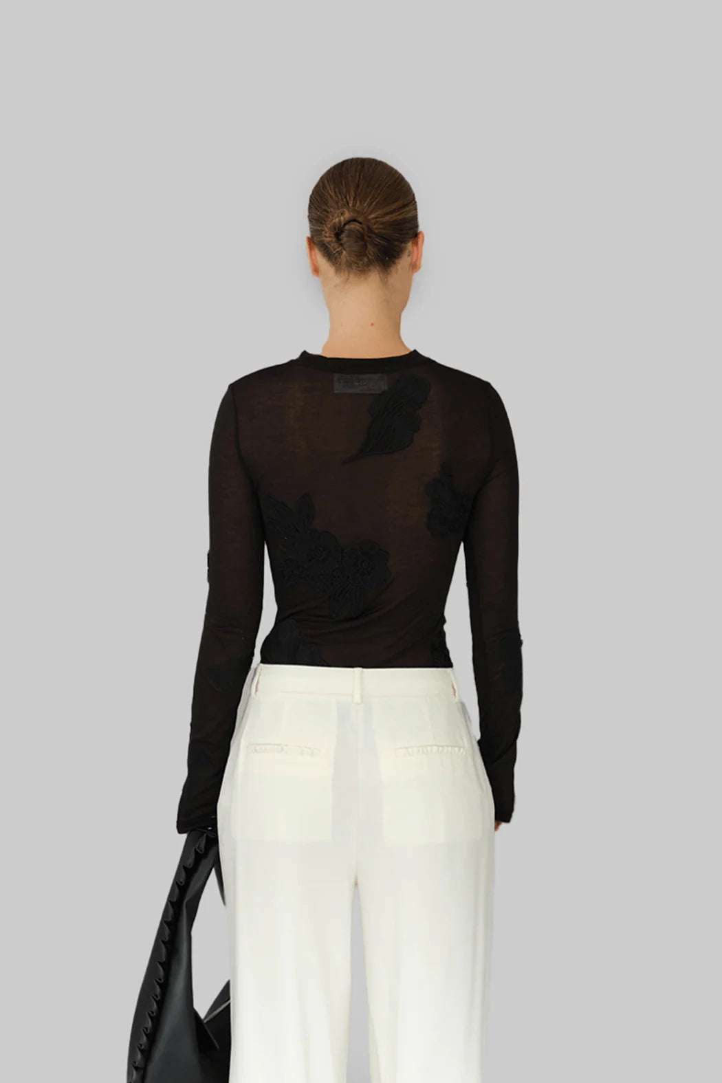 Model wearing OperaSPORT Ziva Top Black back view