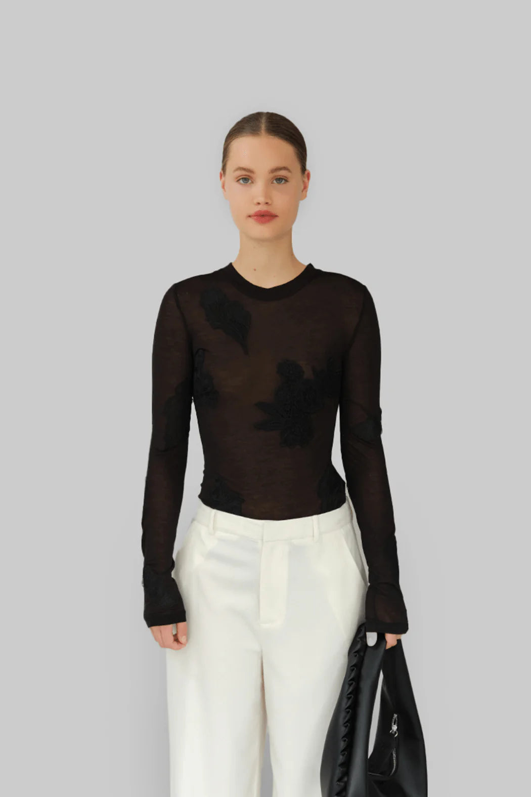 Model wearing OperaSPORT Ziva Top Black front view
