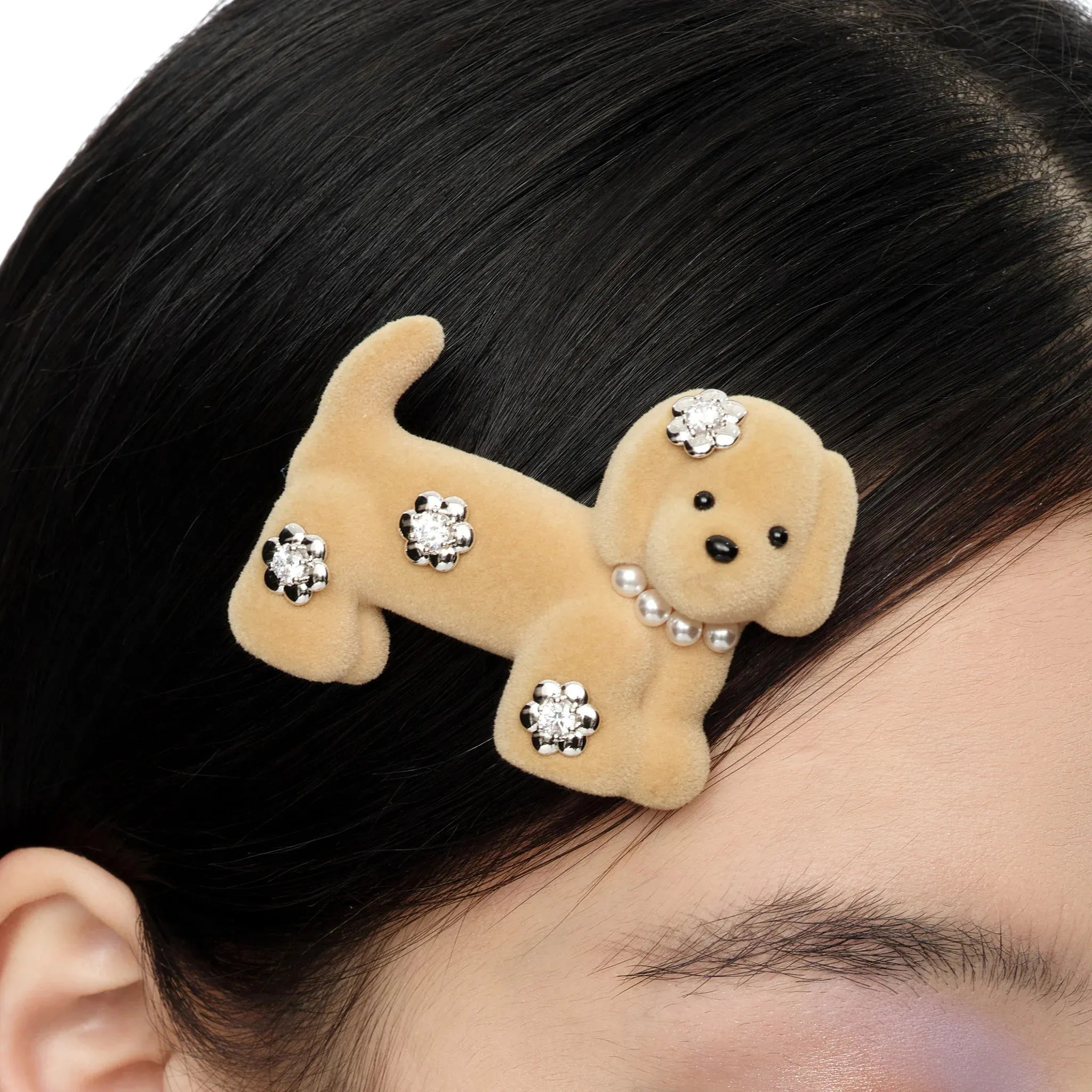 Close-up of Paradise Flower Decoration Puppy Hair Clip light brown worn on black hair