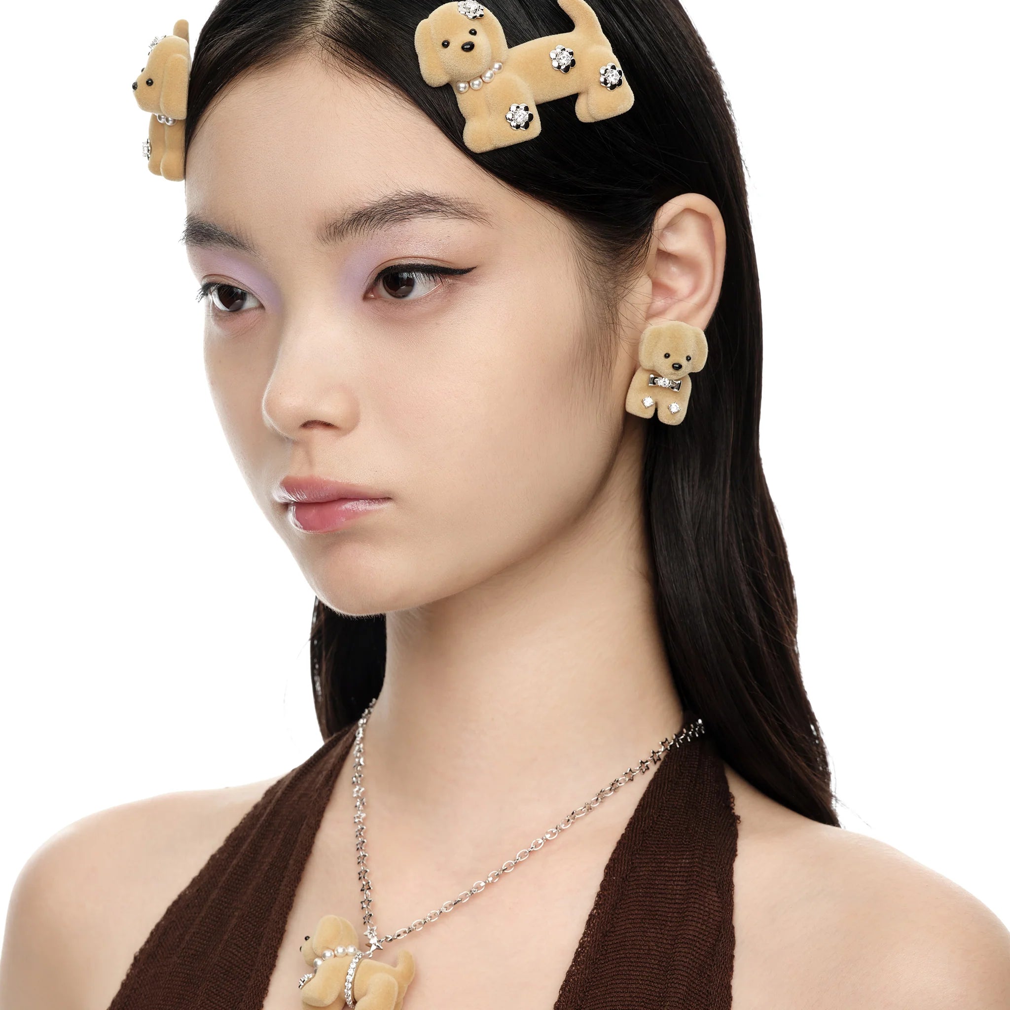 Female model styling Paradise Split Puppy Earring in light brown with matching hair clips