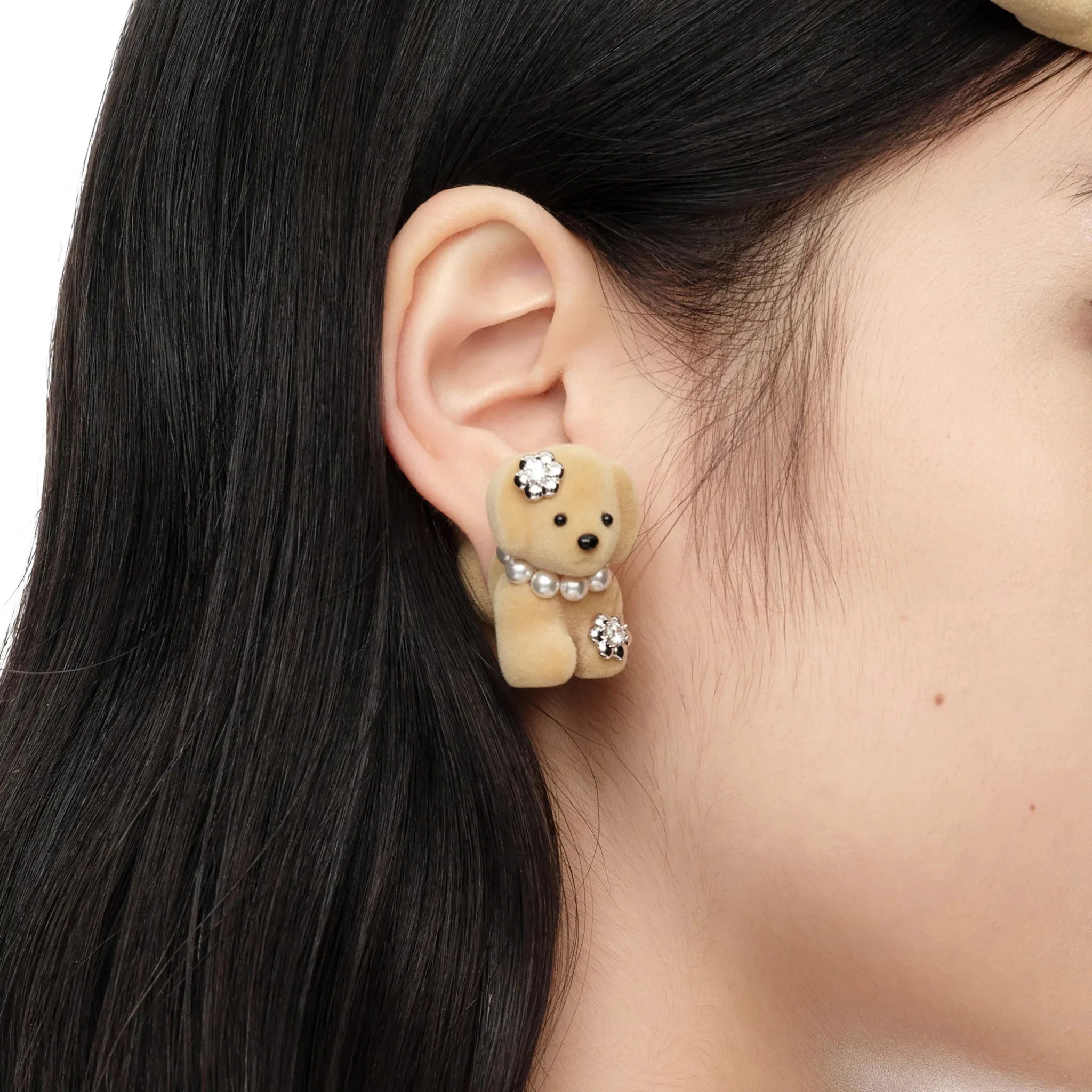 Close-up of Paradise Split Puppy Earring light brown worn on female ear showing split design