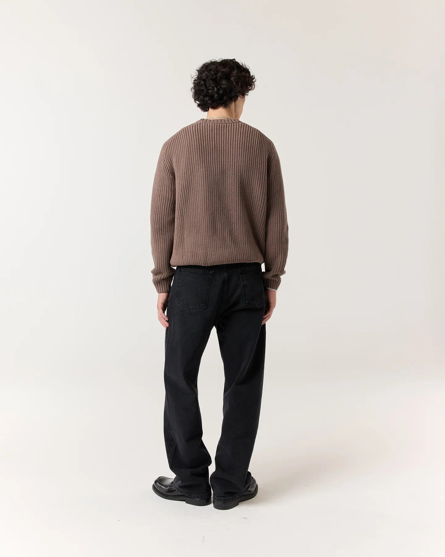 Back view of model wearing RONNING Classic Jeans in Washed Black