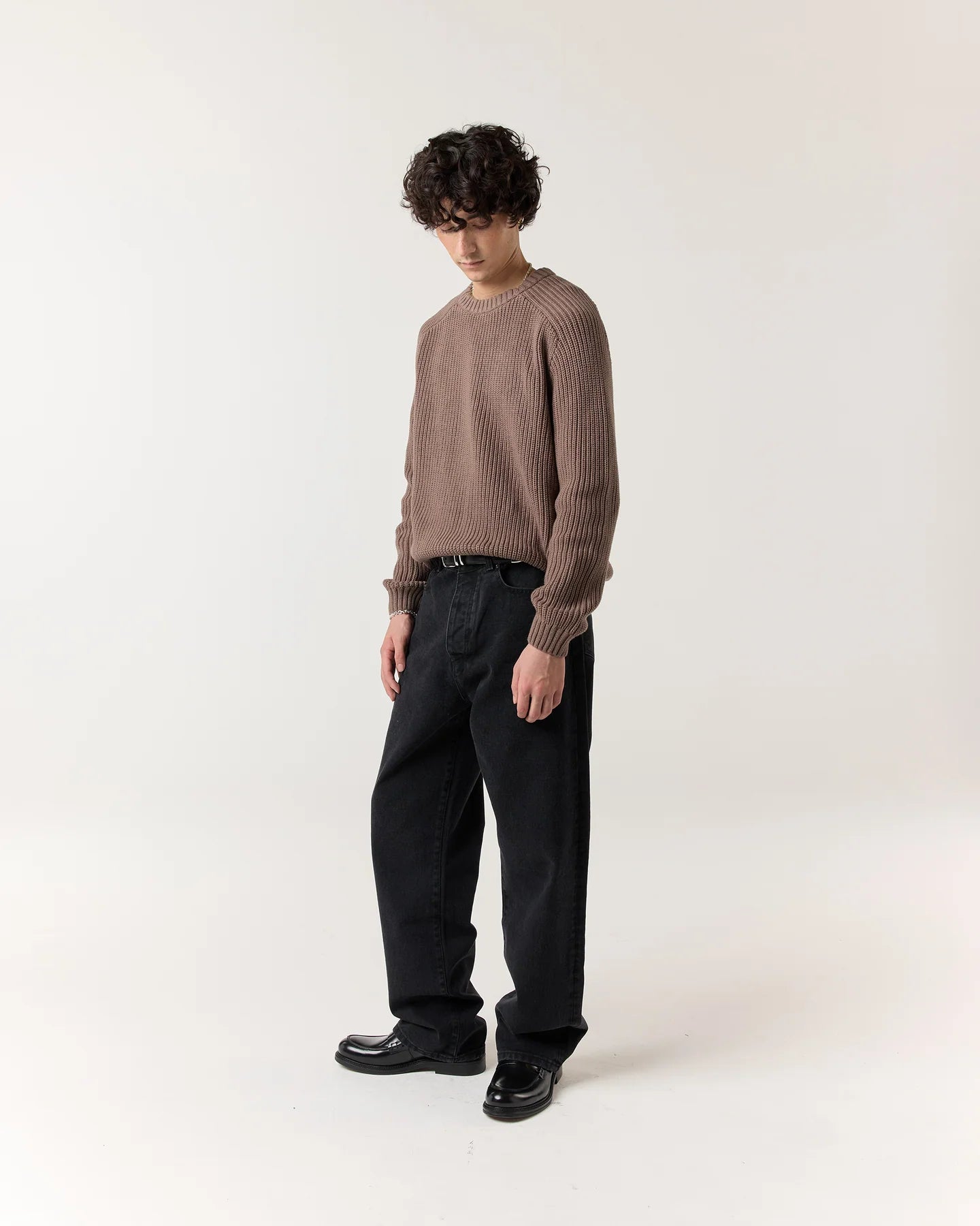 Side view of model wearing RONNING Classic Jeans in Washed Black