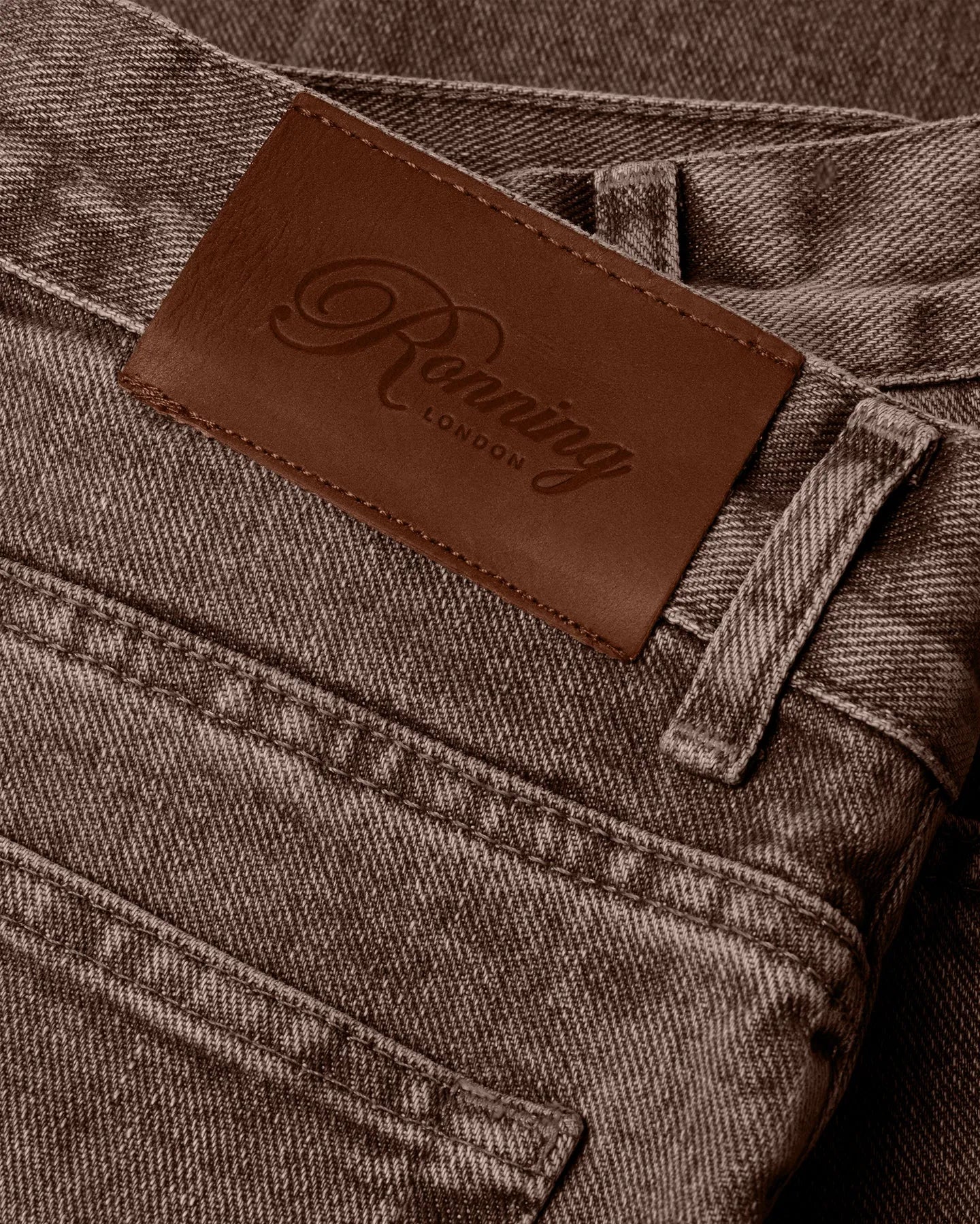 Leather patch detail of RONNING Classic Jeans in Washed Brown