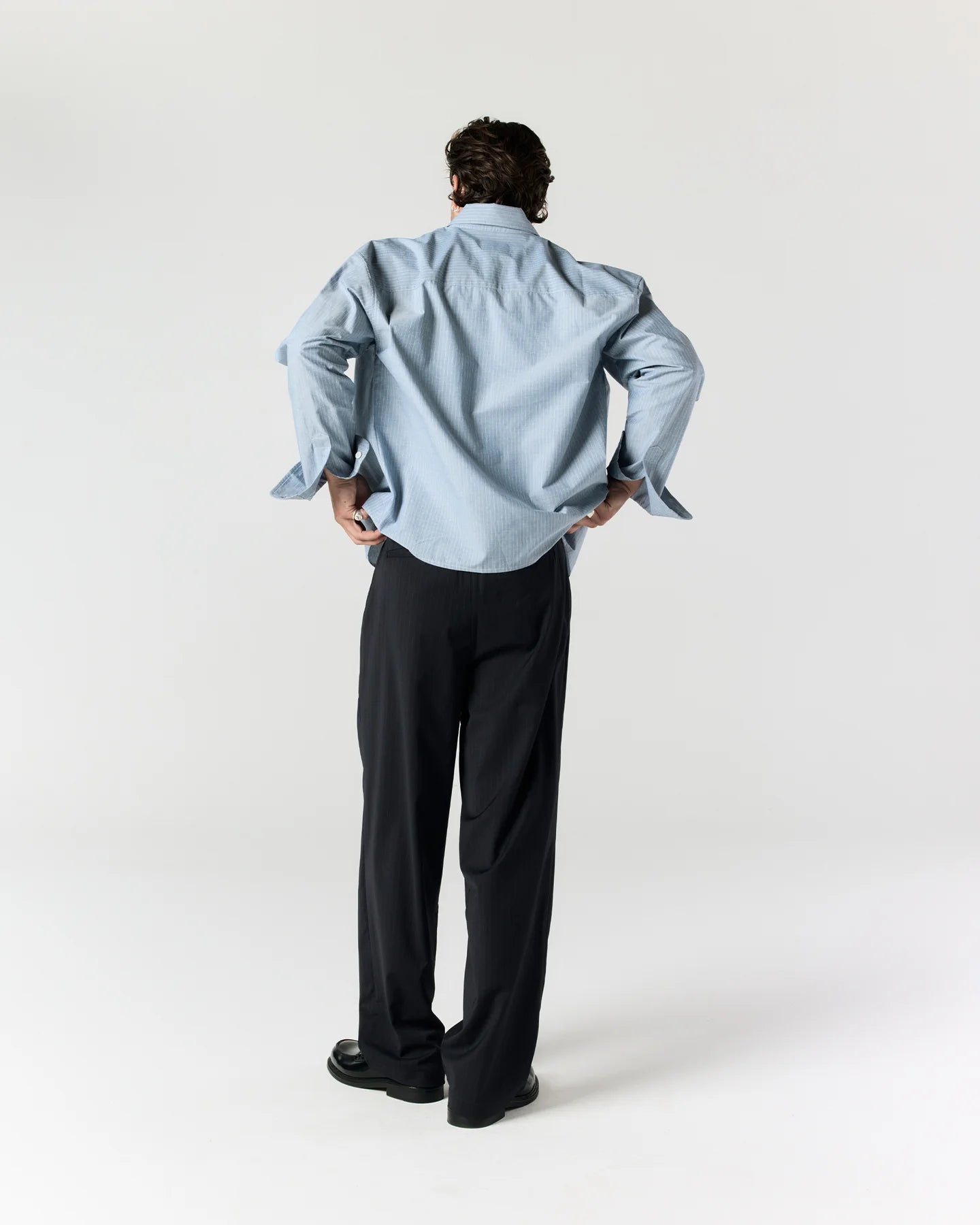 Back view of model wearing RONNING Everyday Shirt in Blue Stripe
