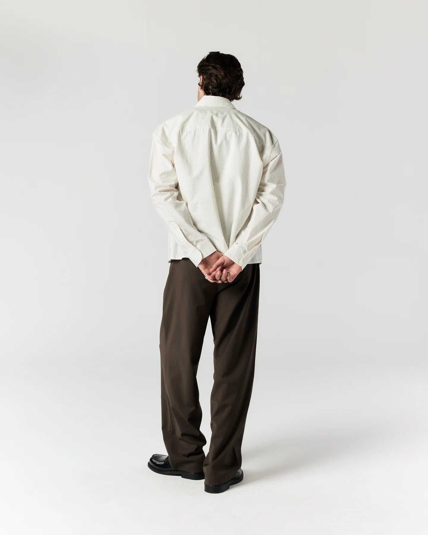 Back view of model wearing RONNING Everyday Shirt in Cream Stripe