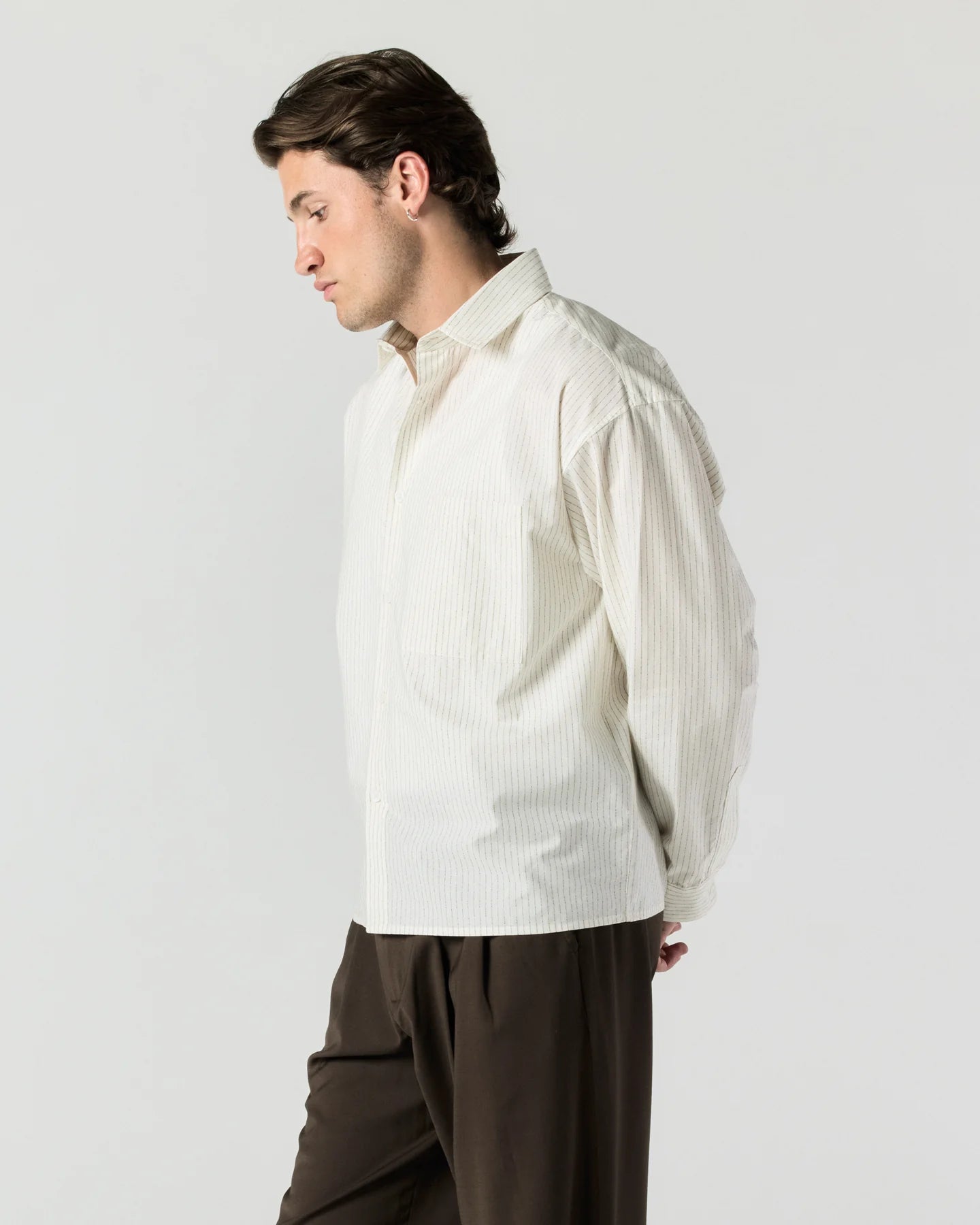 Side view of model wearing RONNING Everyday Shirt in Cream Stripe