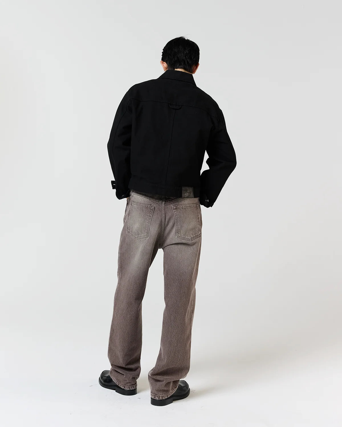 Back view of model wearing Ronning Fatigue Jacket in Black