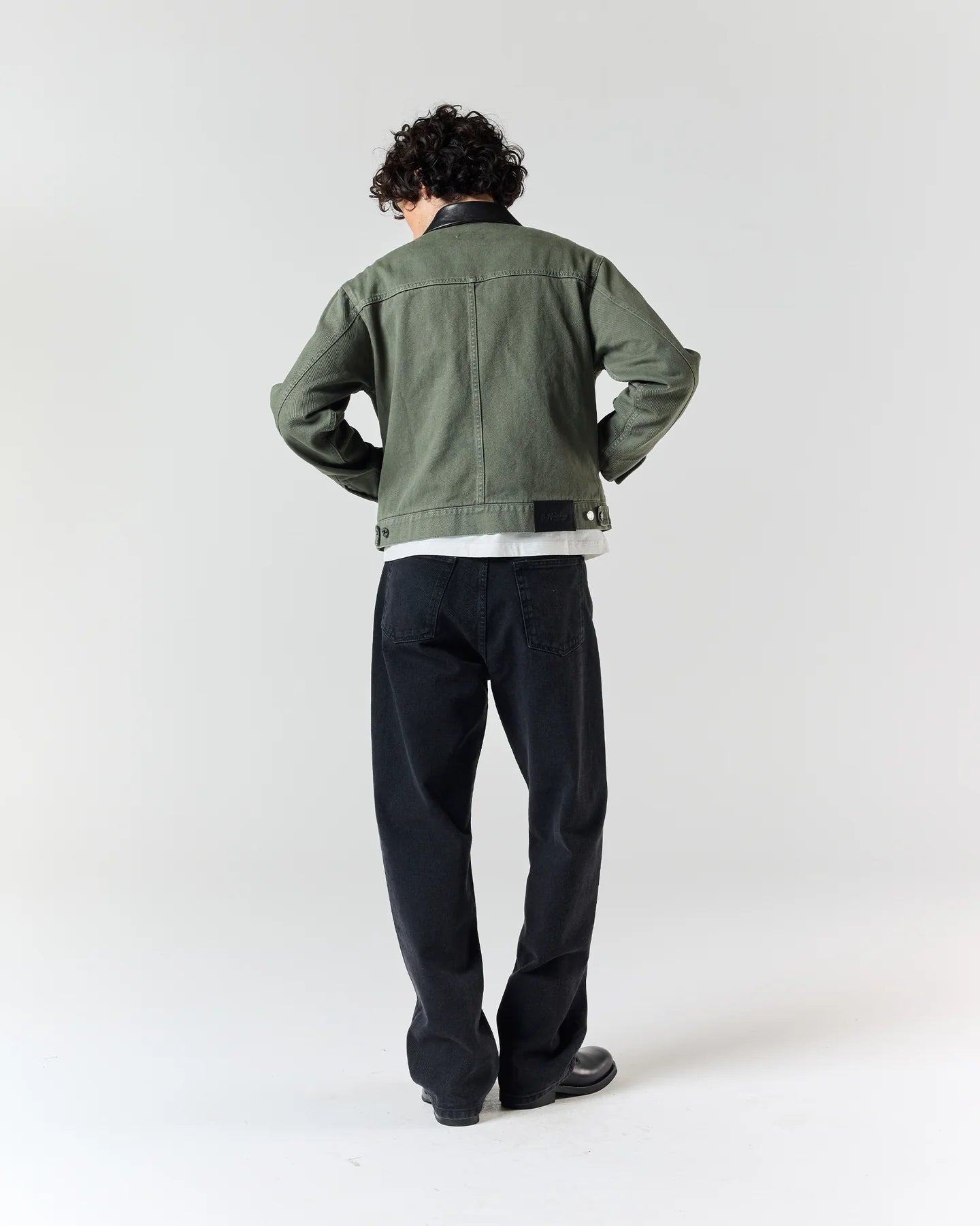 Back view of model wearing RONNING Utility Fireman Jacket in Olive Green