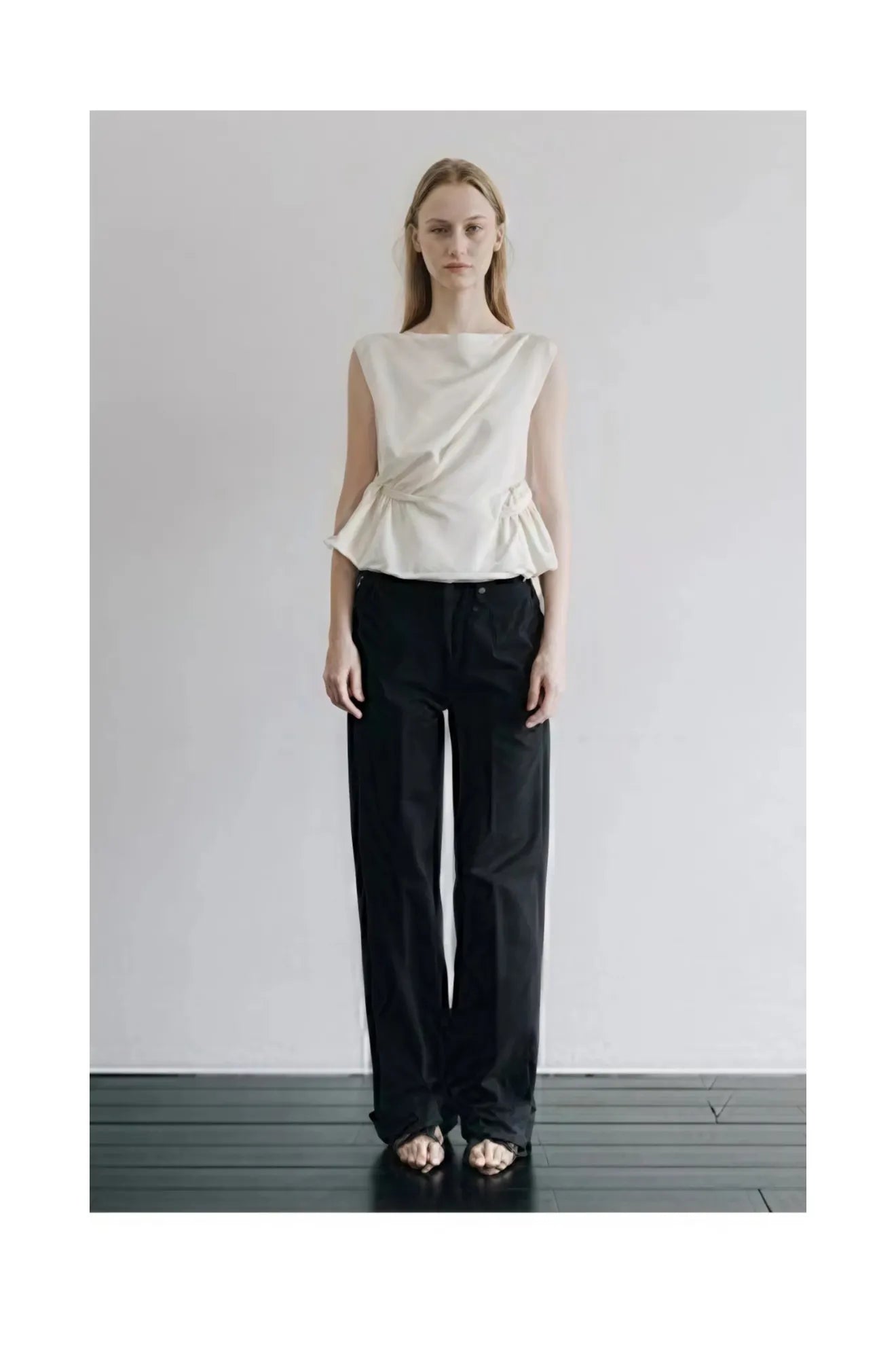 Model wearing Atelier Edition Sleeveless Flounce Blouse in Cream