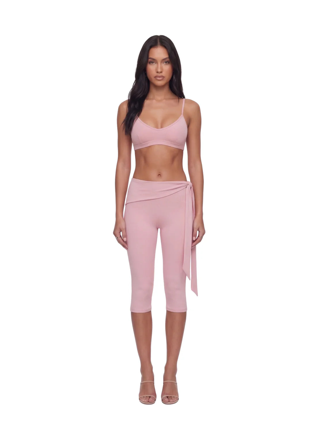 Female model wearing wearrame Drift Adjustable Scoop Bra in Blush pink with matching activewear leggings