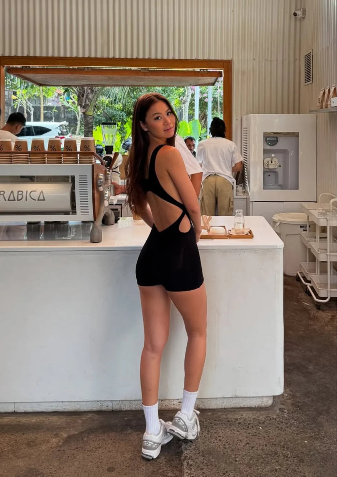Model wearing Wearrame Leda Dynamic Onesie Black outdoors