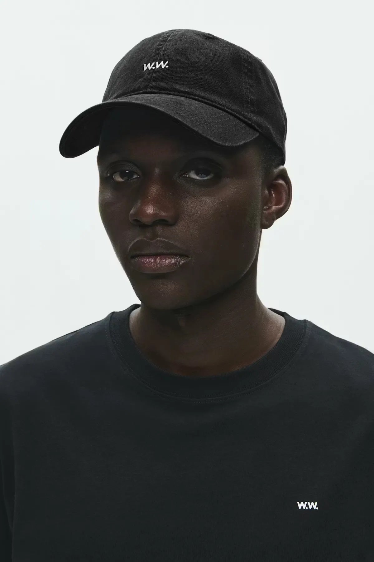 Model wearing Wood Wood W.W. Cap in Black front view