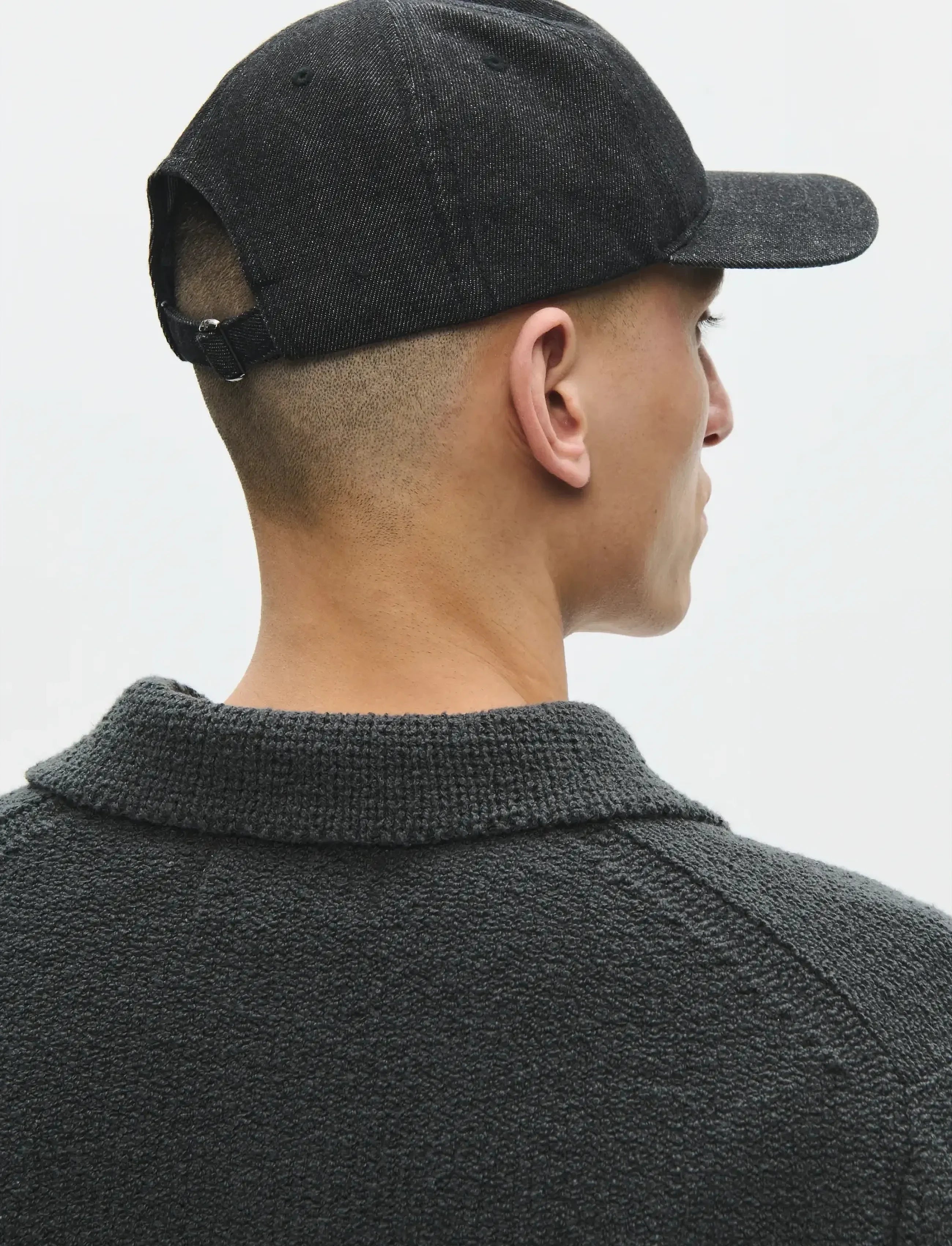 Back view of model wearing Wood Wood W.W. Cap in Black Sand