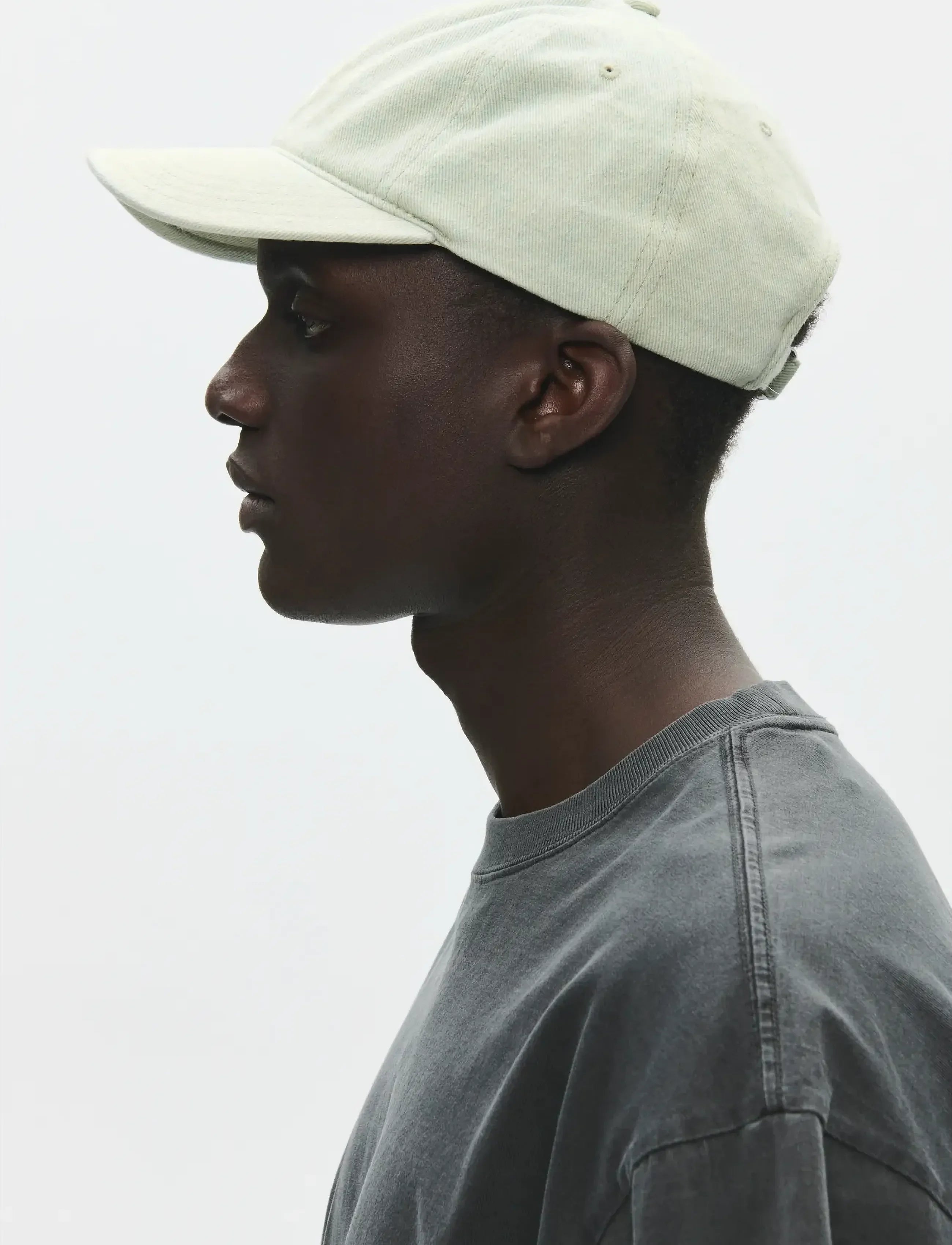 Side view of model wearing Wood Wood W.W. Cap in Light Blue Denim