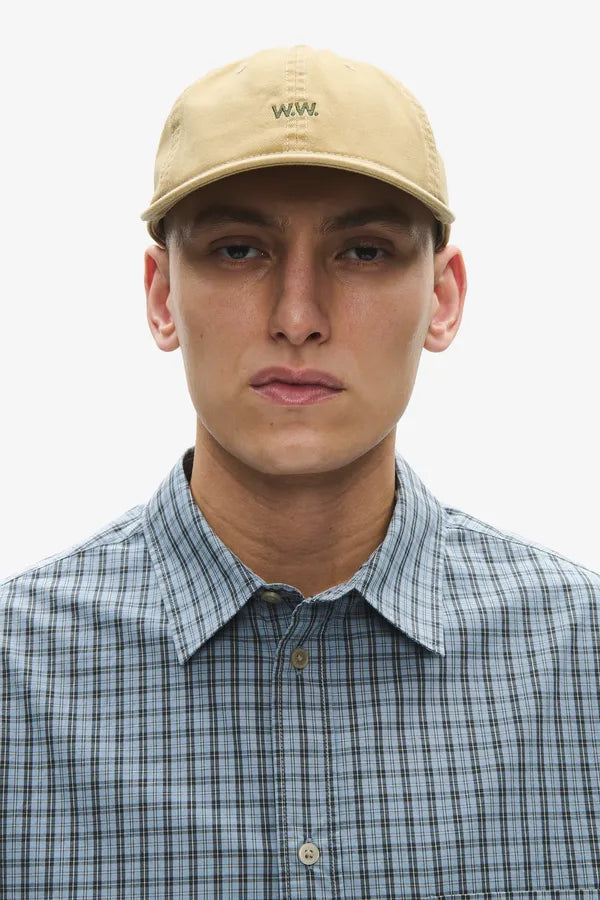 Model wearing Wood Wood W.W. Cap Pale Olive Green