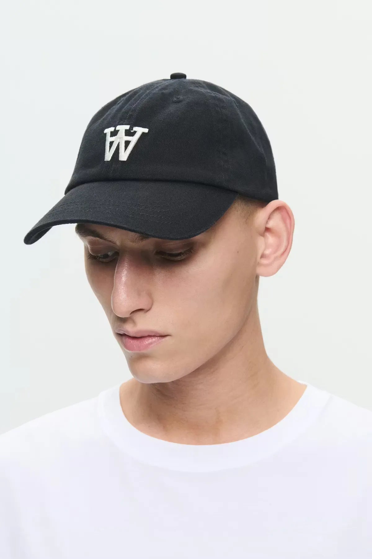 Model wearing Wood Wood WWEli Cap in Black