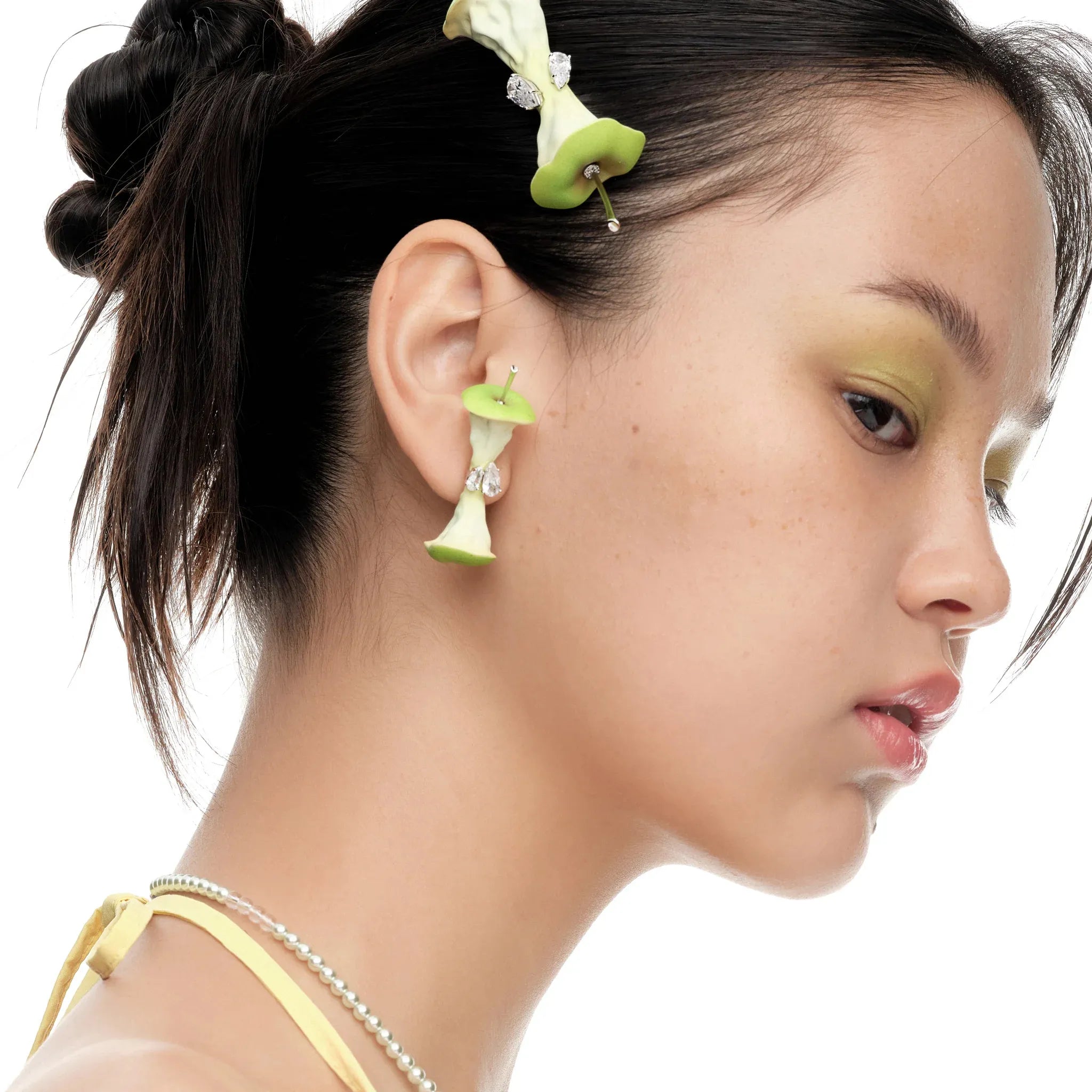 Model wearing YVMIN Paradise Apple Core Earring Green