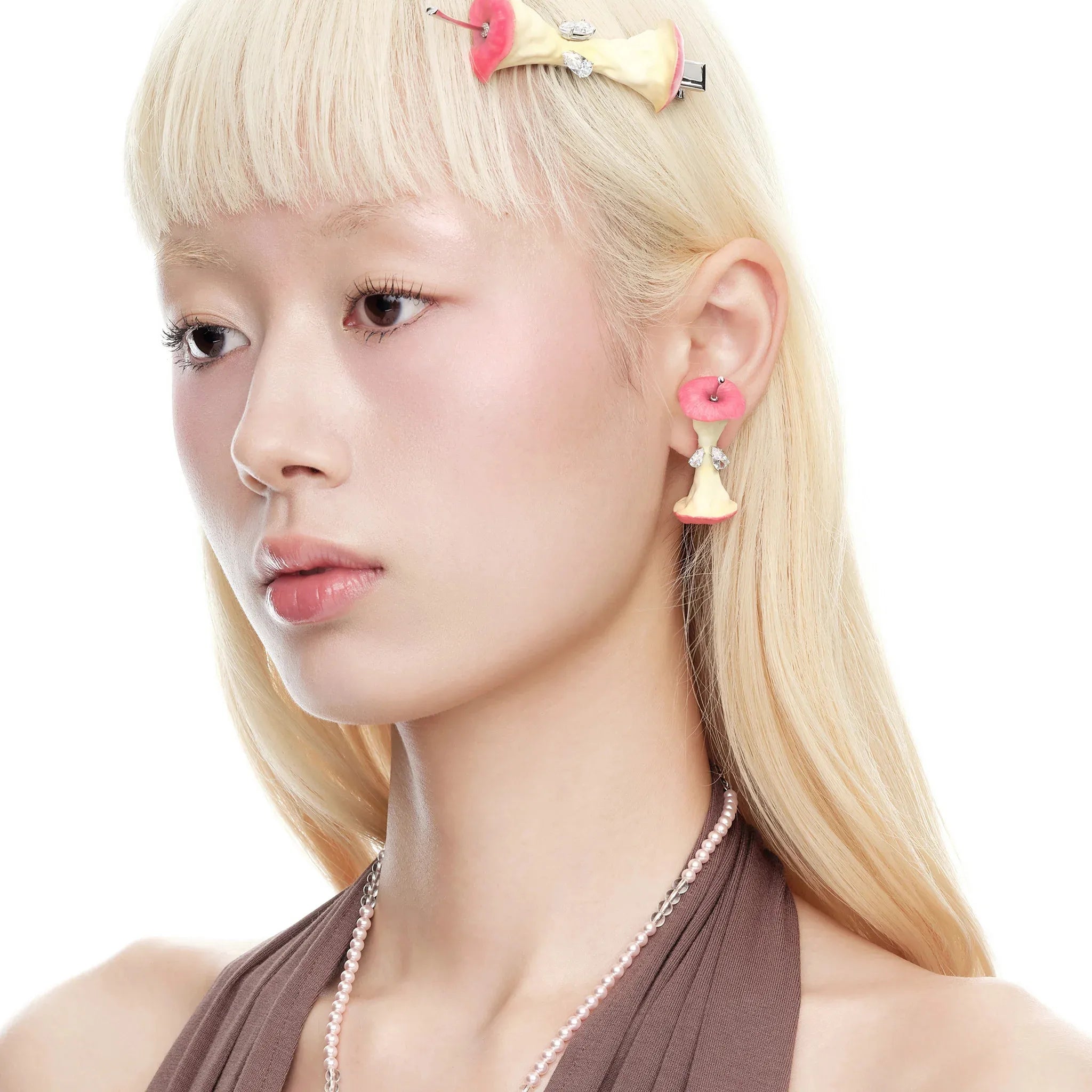 Model wearing YVMIN Paradise Apple Core Earring Red