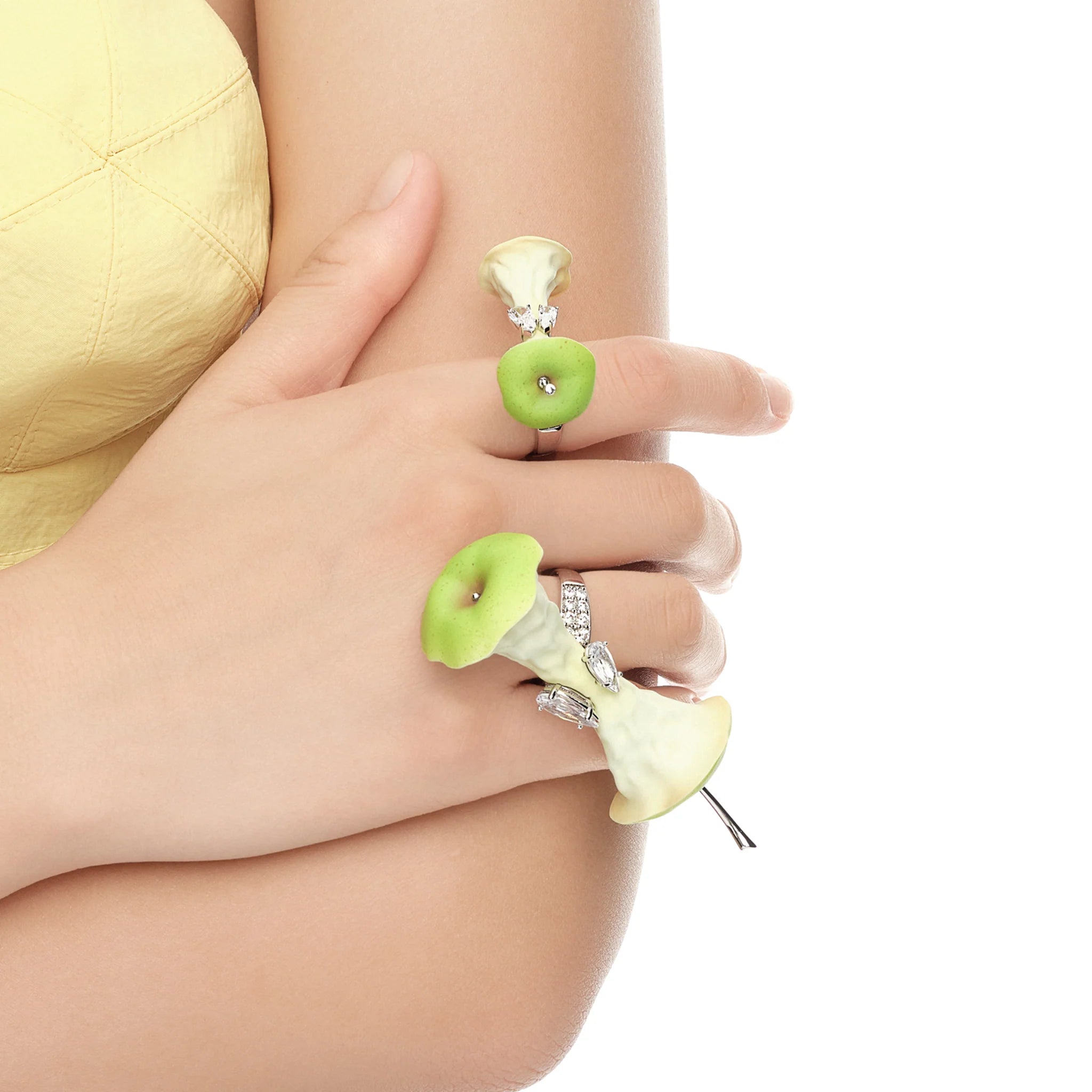 Close-up of YVMIN Paradise Apple Core Spin Ring Green on hand