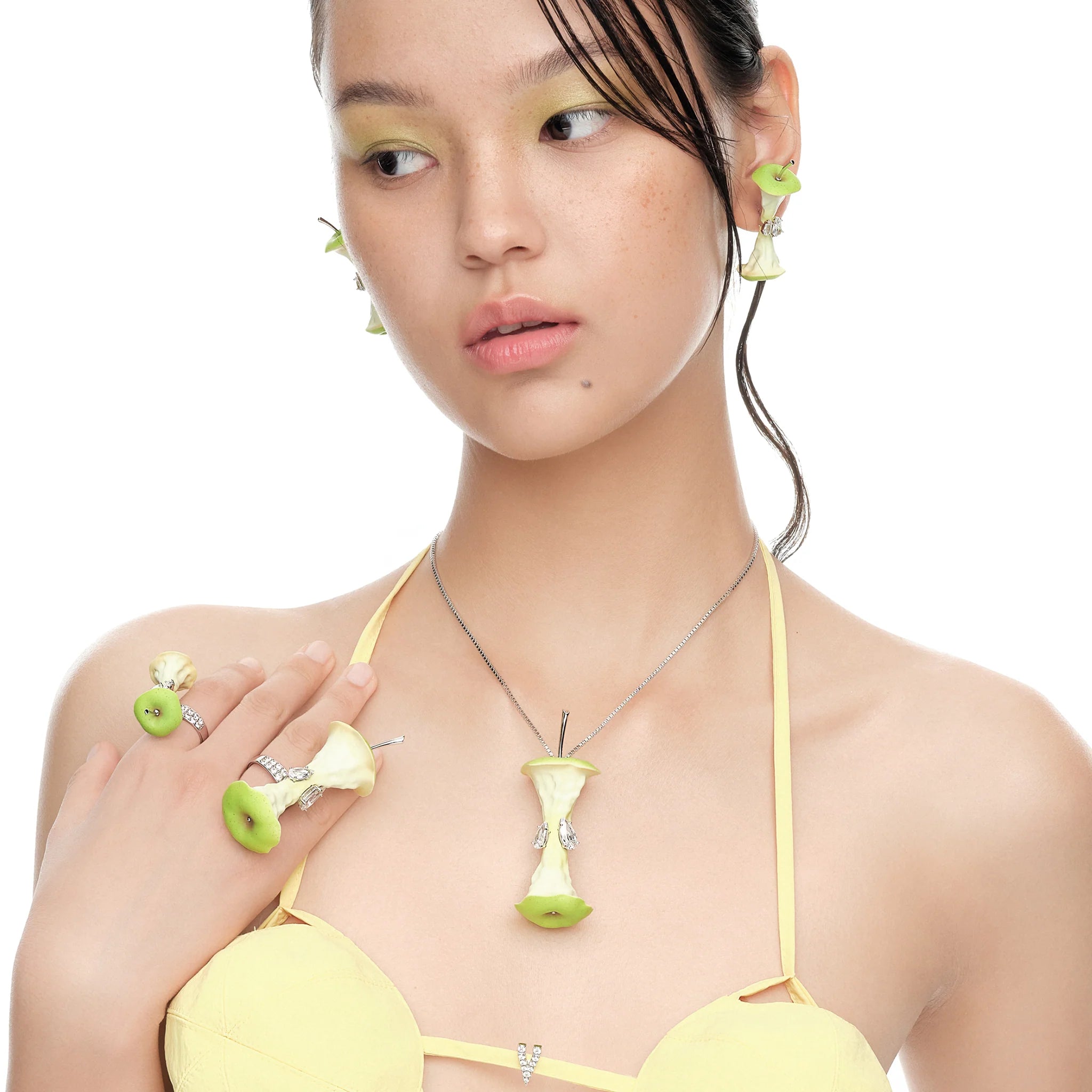 Model wearing YVMIN Paradise Apple Core Spin Ring Green