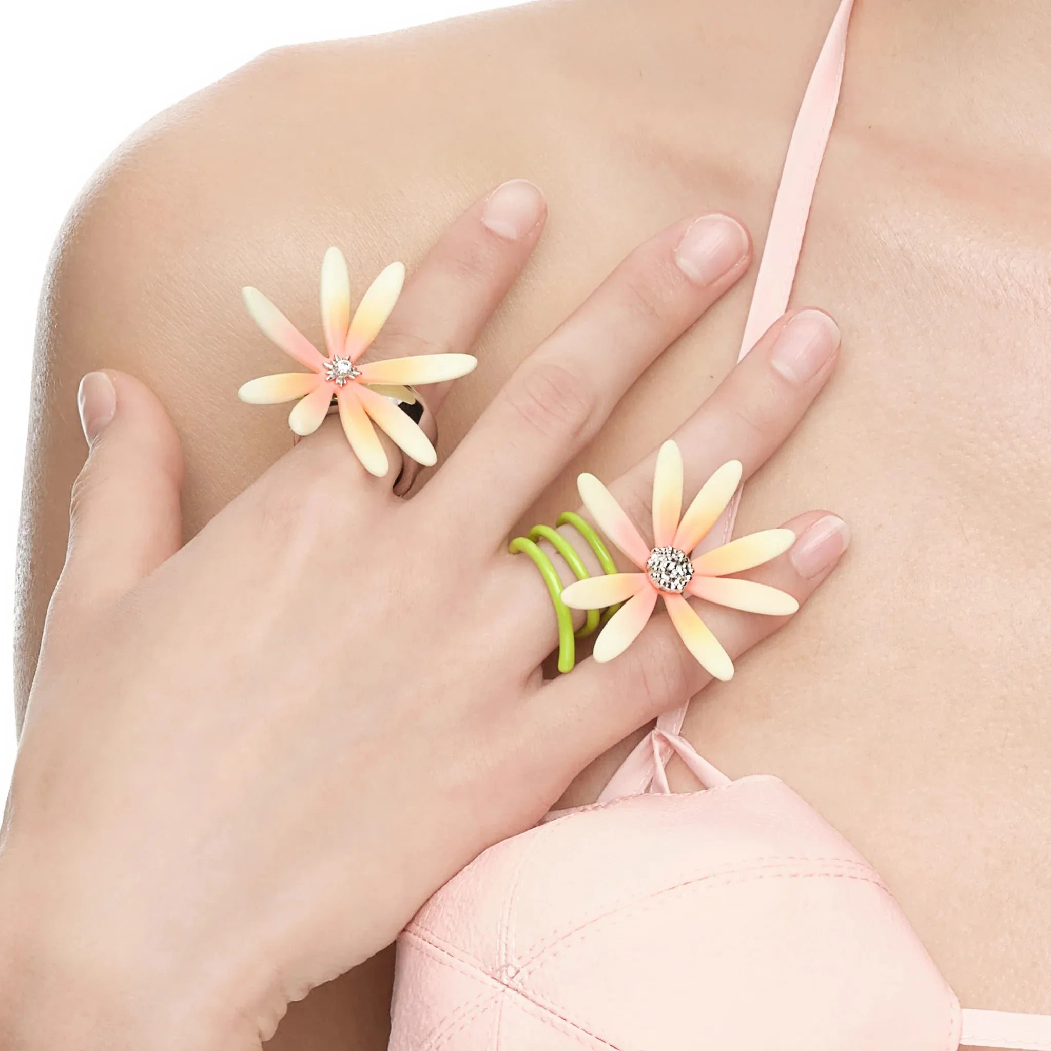 Close-up of YVMIN Paradise Daisy Vines Cross Ring Pink on hand