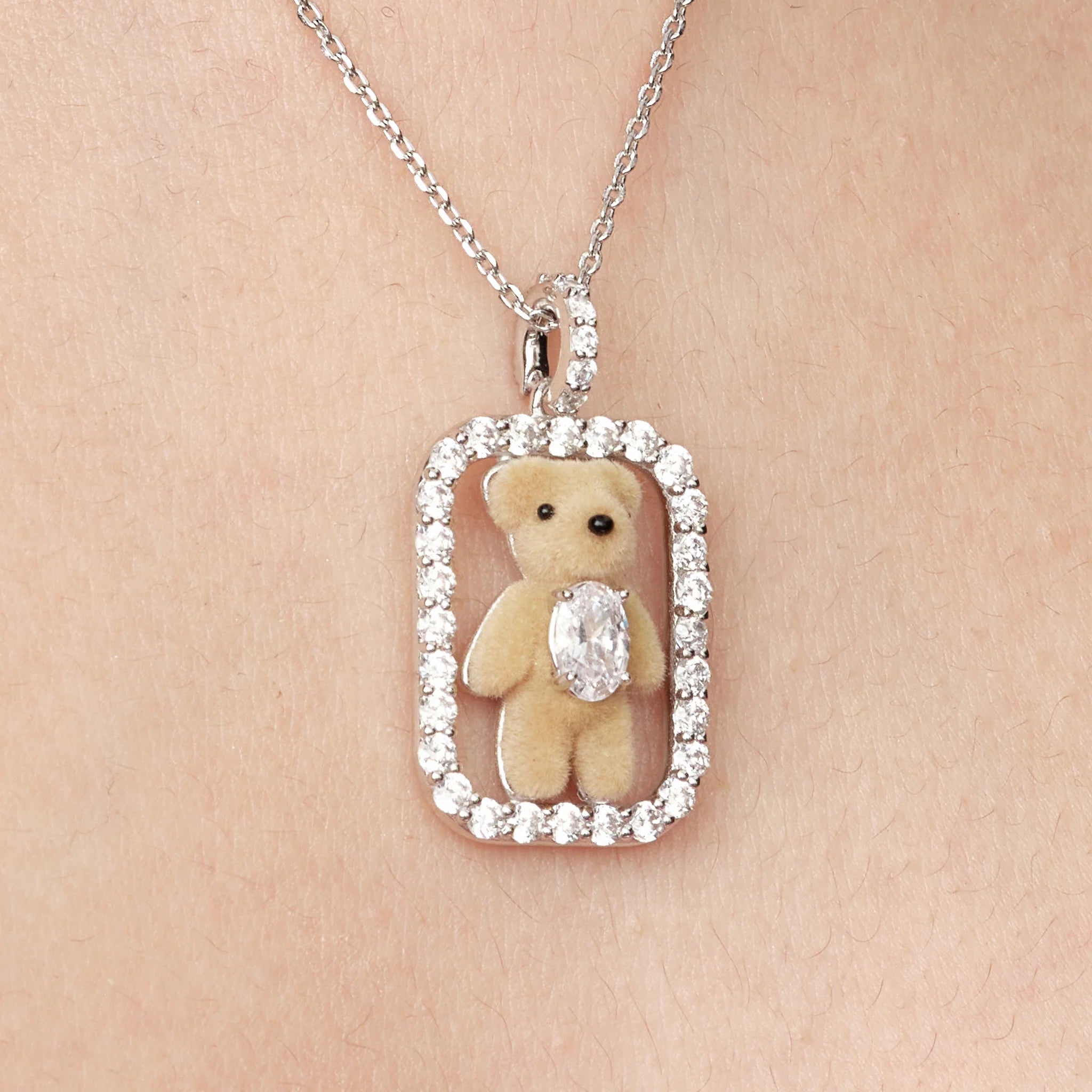 Close-up of the mini bear pendant on YVMIN Paradise Inlaid Mini Bear Necklace in Silver