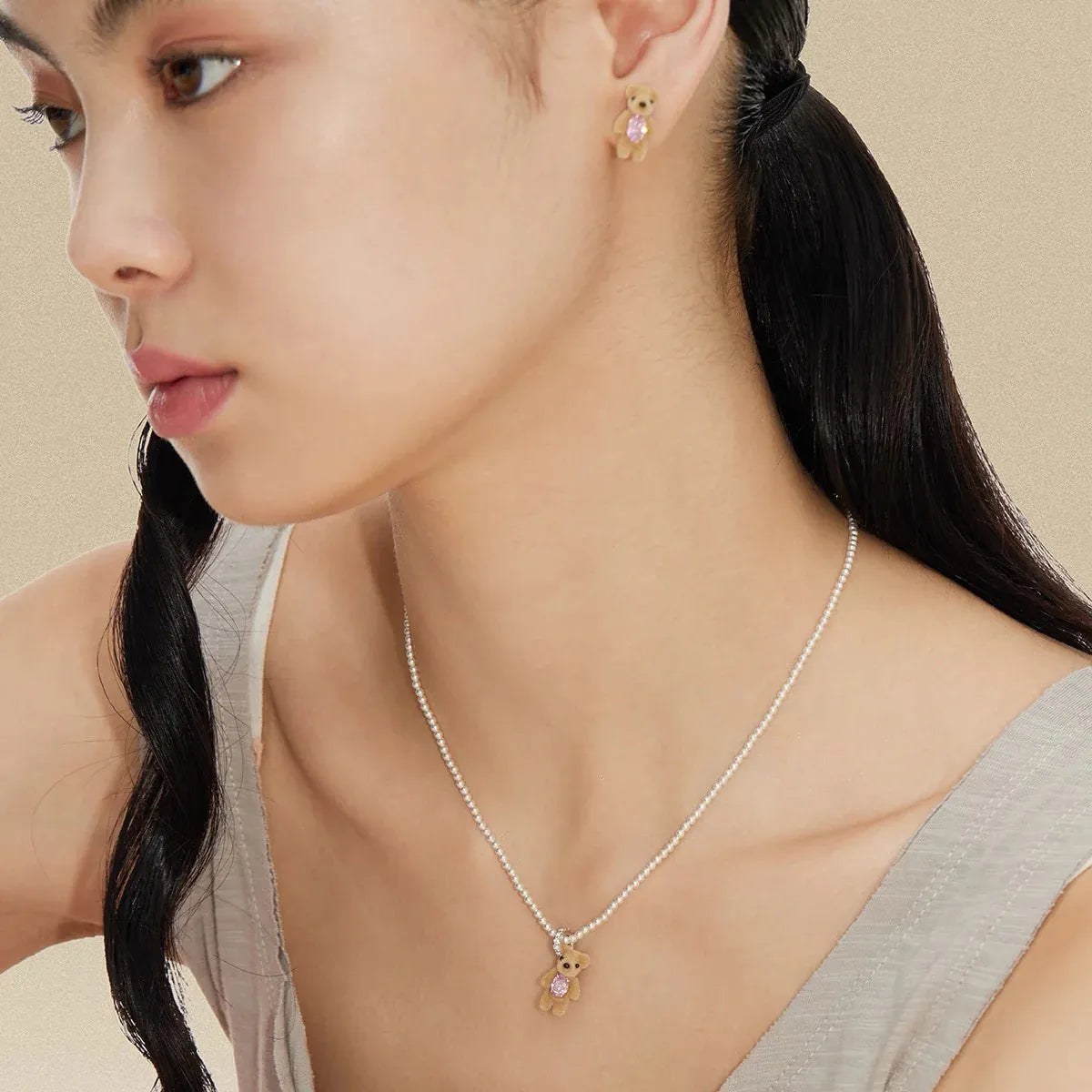 Model wearing YVMIN Paradise Mini Flocked Bear Pearl Necklace