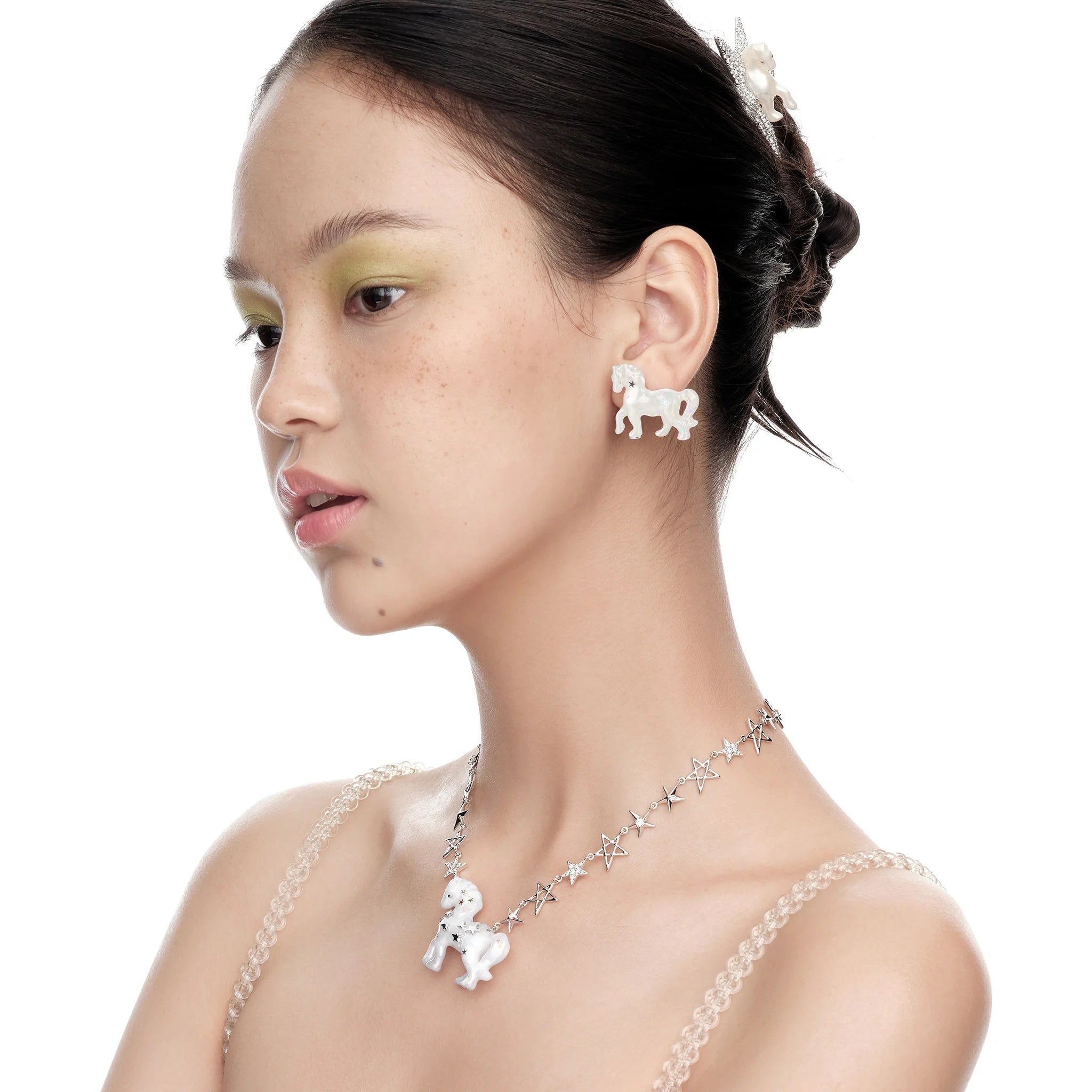 Model wearing YVMIN Paradise Pony Earrings in White