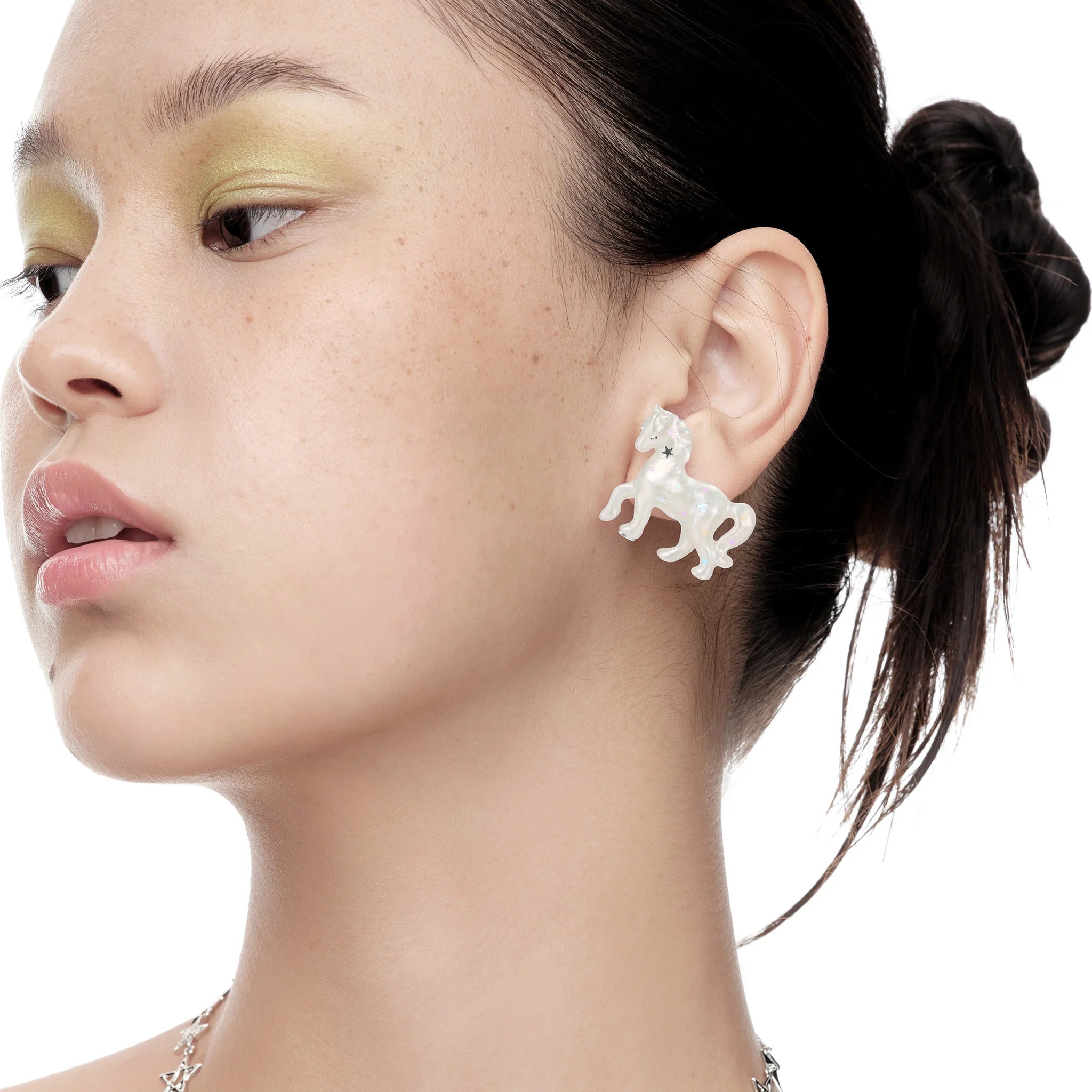 Side portrait of model wearing YVMIN Paradise Pony Earrings