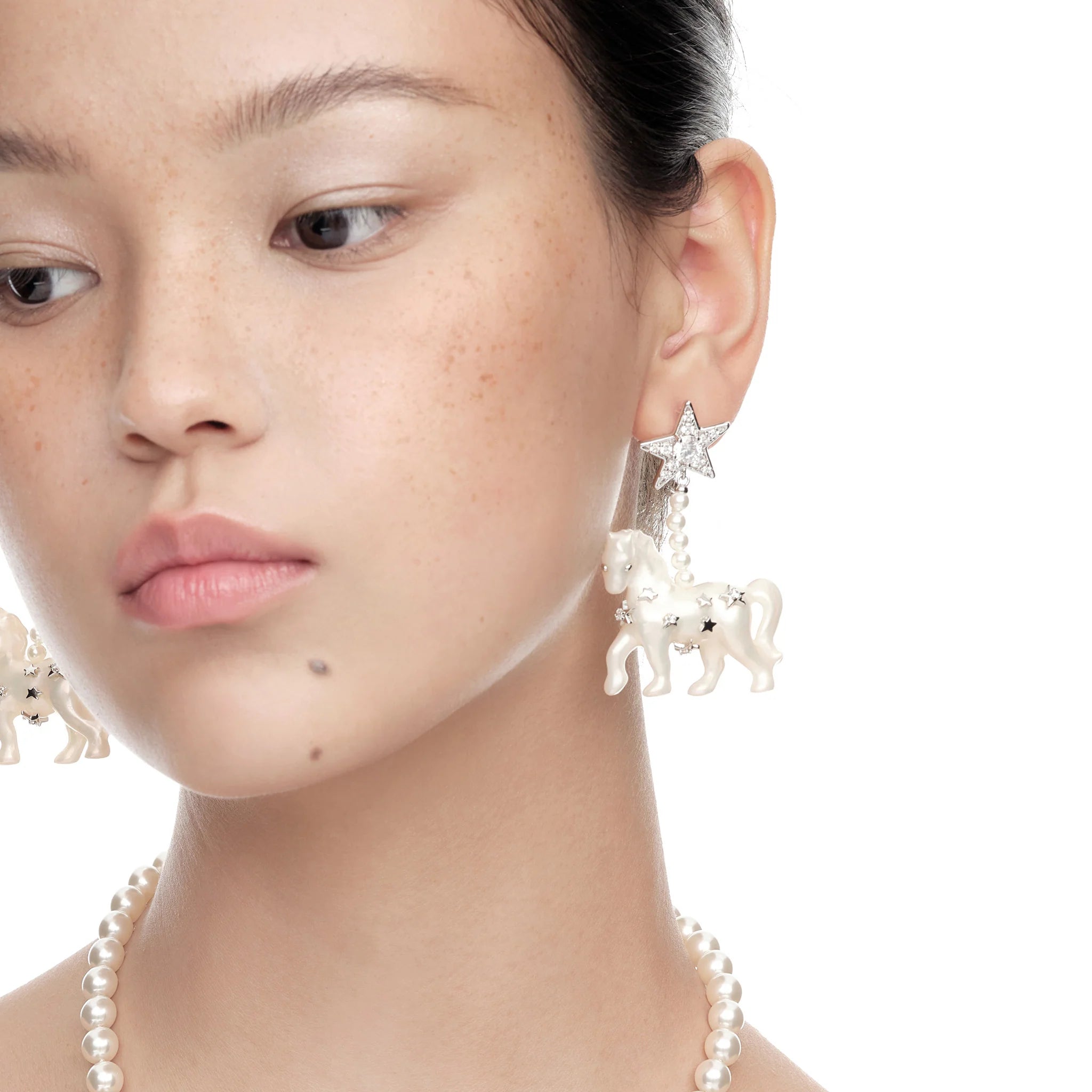 Portrait of model wearing YVMIN Paradise Pony Pendant Earrings