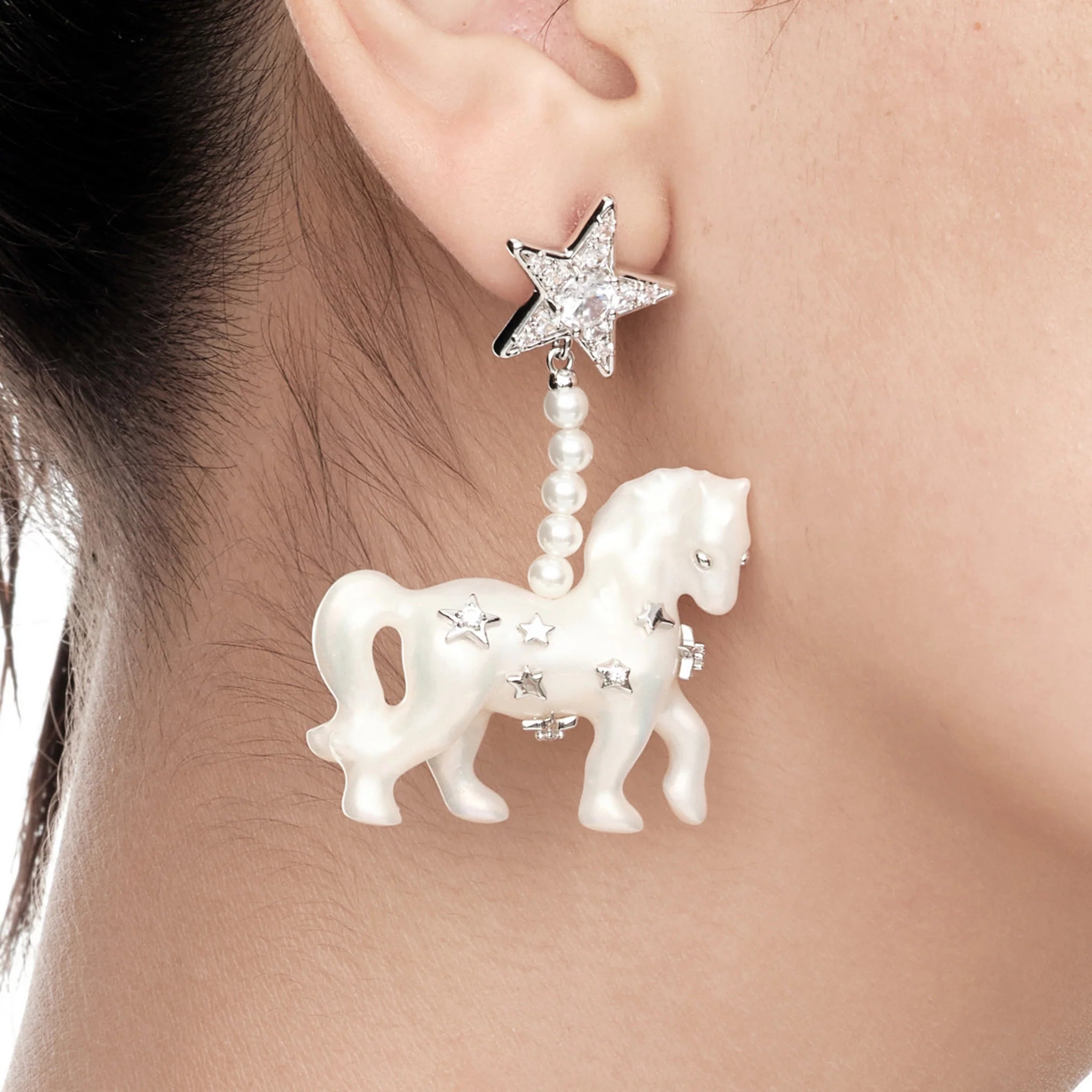Close-up of YVMIN Paradise Pony Pave Star Pendant Earrings