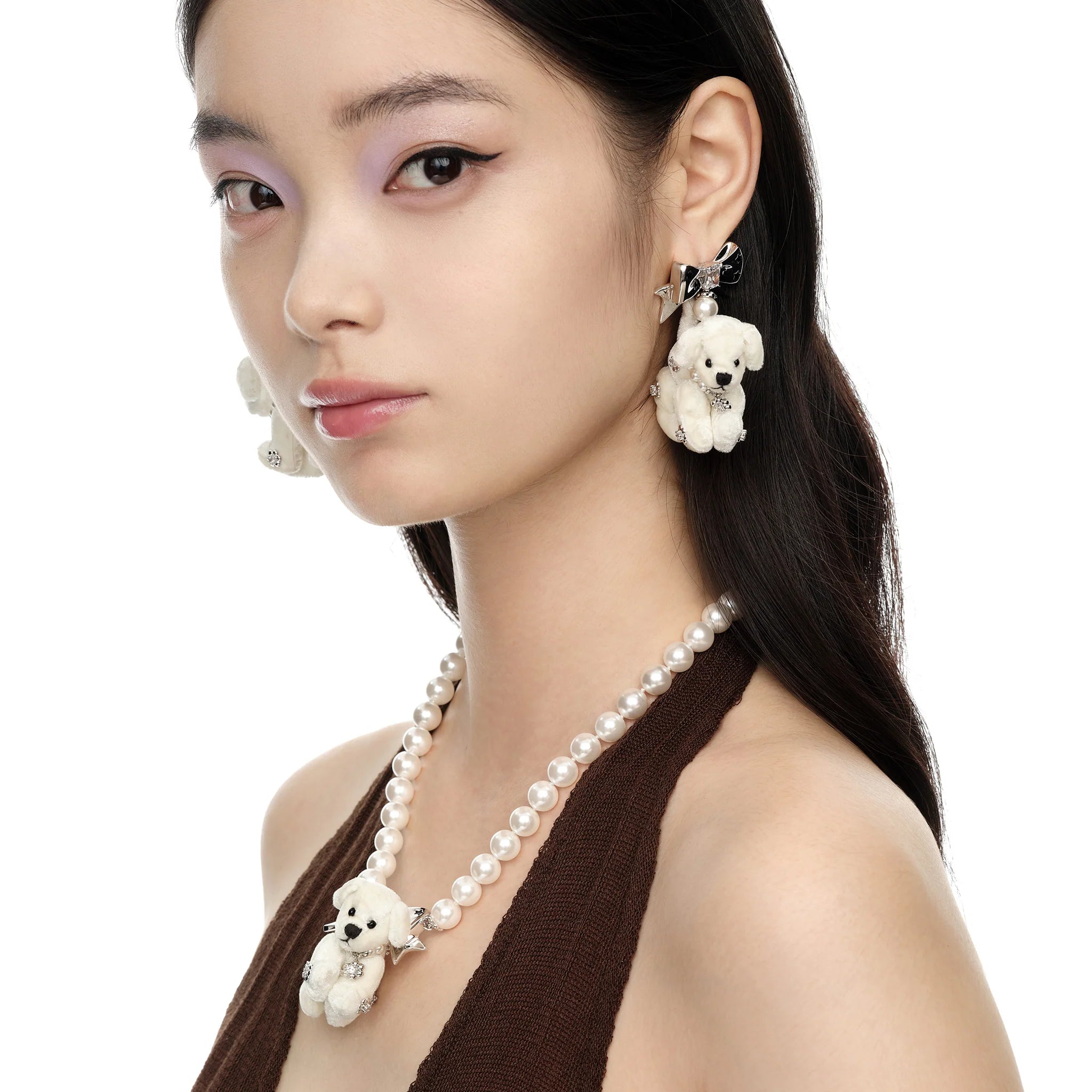 Model wearing YVMIN Paradise Puppy Earrings in White