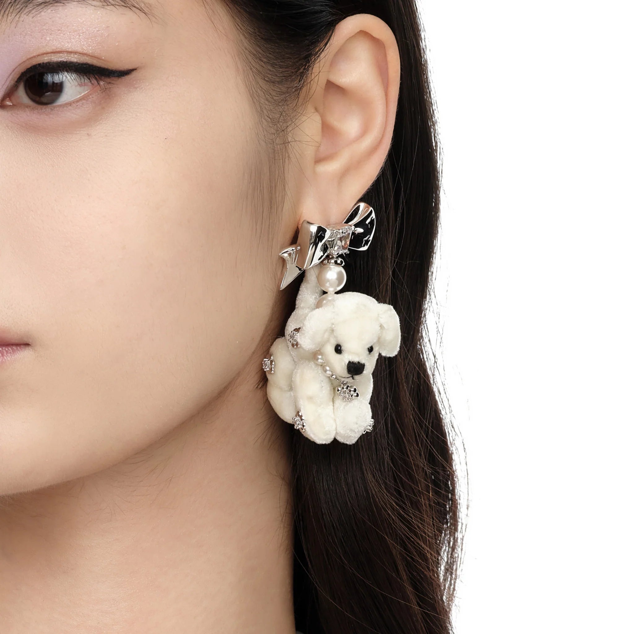 Close-up of model wearing YVMIN Paradise Puppy Earrings