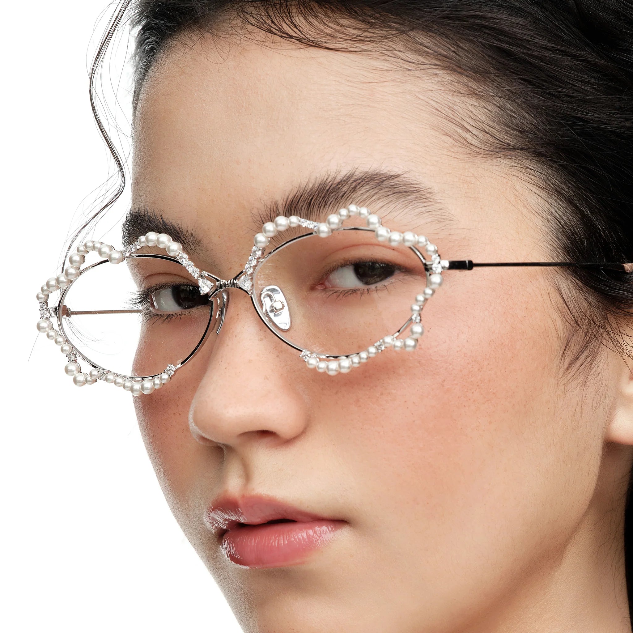 Close-up of model wearing YVMIN Paradise Waving Pearl Glasses in Silver
